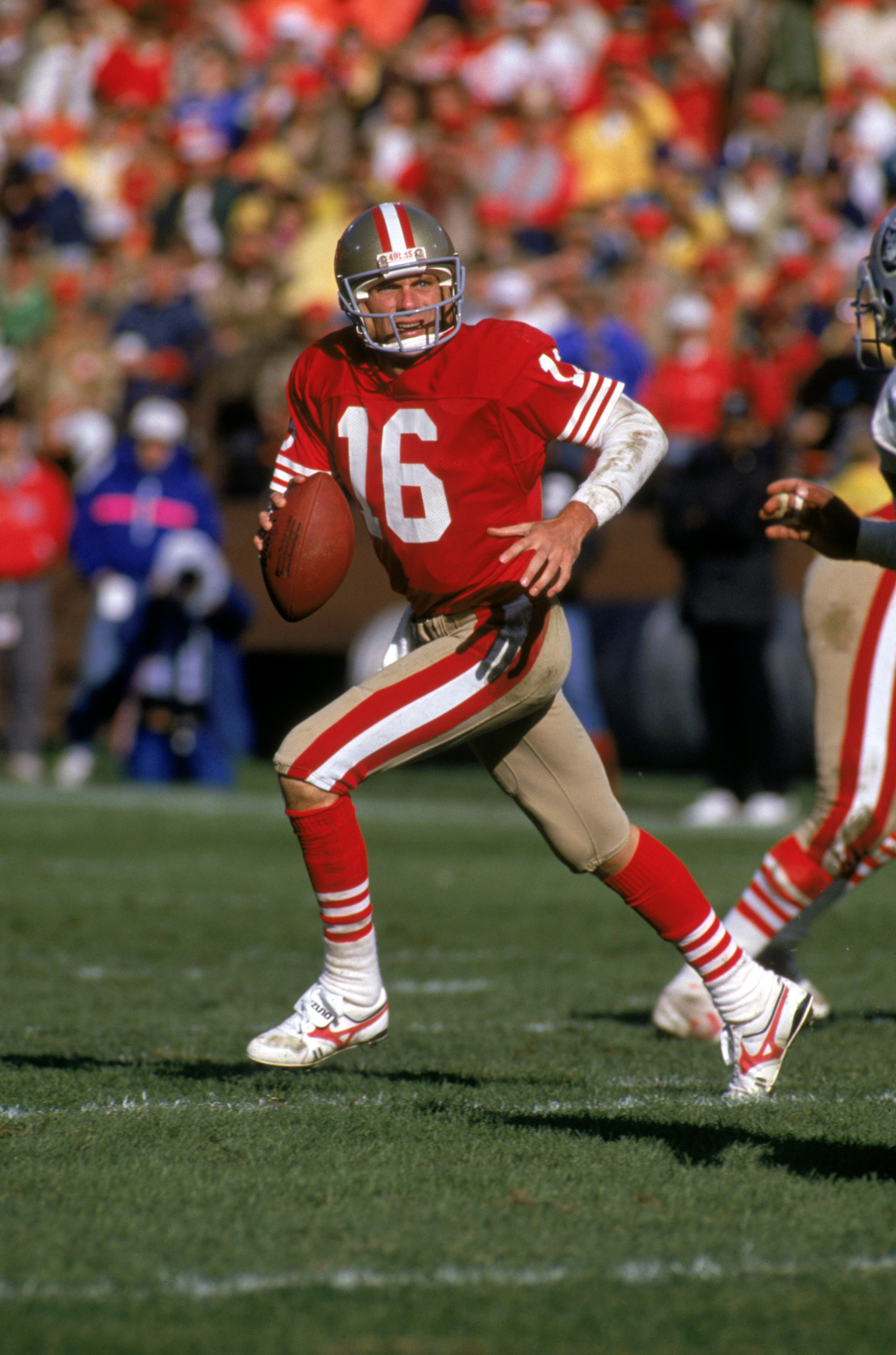 SAN FRANCISCO - NOVEMBER 13: Quarterback Joe Montana #16 of the San Francisco 49ers runs with the ball as he looks down field for a receiver during a game against the Los Angeles Raiders at Candlestick Park on November 13, 1988 in San Francisco, Californ SAN FRANCISCO - NOVEMBER 13: Quarterback Joe Montana #16 of the San Francisco 49ers runs with the ball as he looks down field for a receiver during a game against the Los Angeles Raiders at Candlestick Park on November 13, 1988 in San Francisco, Californ