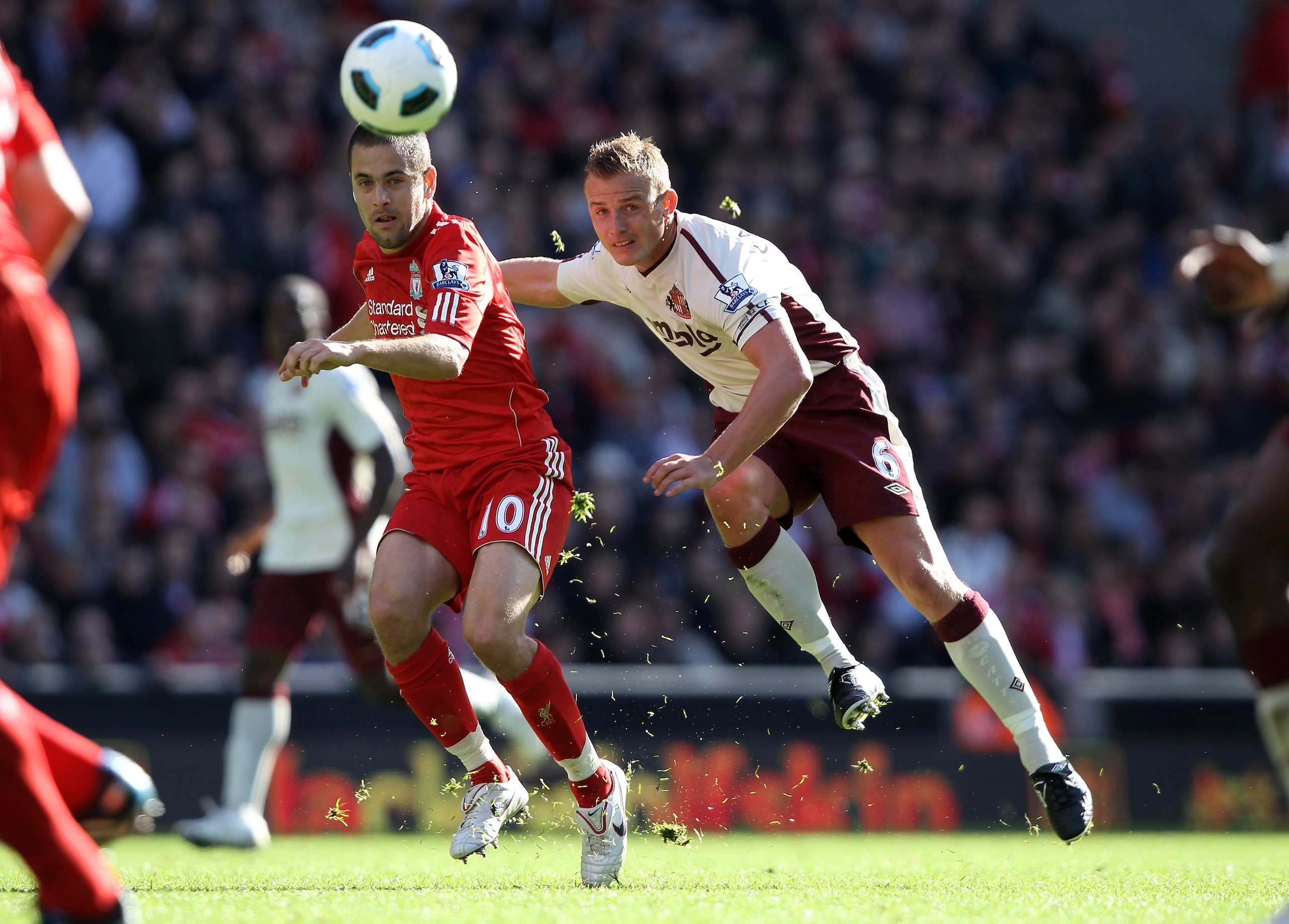 LIVERPOOL, ENGLAND - SEPTEMBER 25: Lee Cattermole of Sunderland shoots past Joe Cole of Liverpool during the Barclays Premier League match between Liverpool and Sunderland at at Anfield on September 25, 2010 in Liverpool, England.  (Photo by Clive Brunski