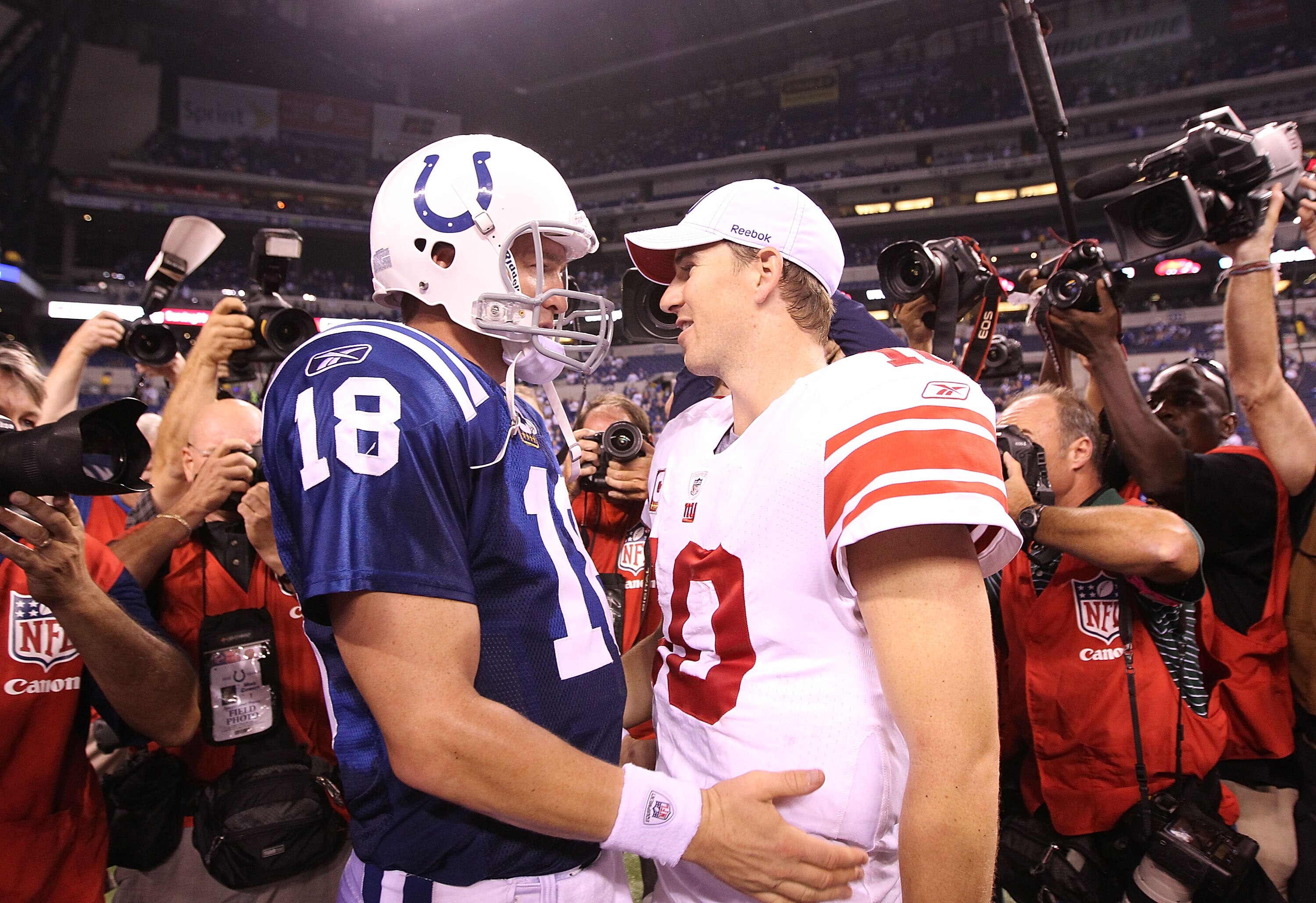 INDIANAPOLIS - SEPTEMBER 19:  Eli Manning #10 of the New York Giants and Peyton Manning #18 of the Indianapolis Colts embrace following the Colts 38-14 win at Lucas Oil Stadium on September 19, 2010 in Indianapolis, Indiana.  (Photo by Andy Lyons/Getty Im