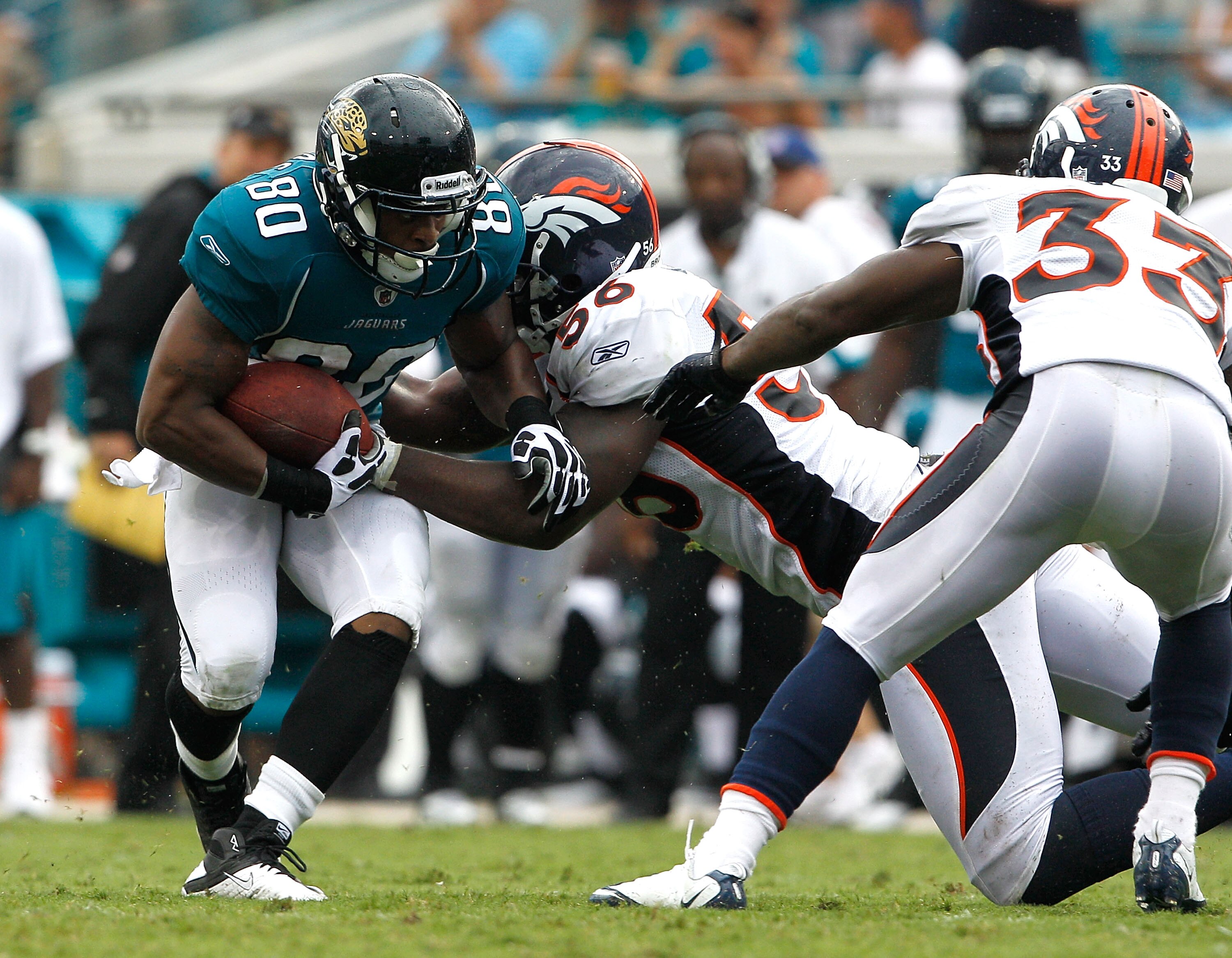 JACKSONVILLE, FL - SEPTEMBER 12:  Robert Ayers #56 of the Denver Broncos attempts to tackle Mike Thomas #80 of the Jacksonville Jaguars during the NFL season opener game at EverBank Field on September 12, 2010 in Jacksonville, Florida.  (Photo by Sam Gree