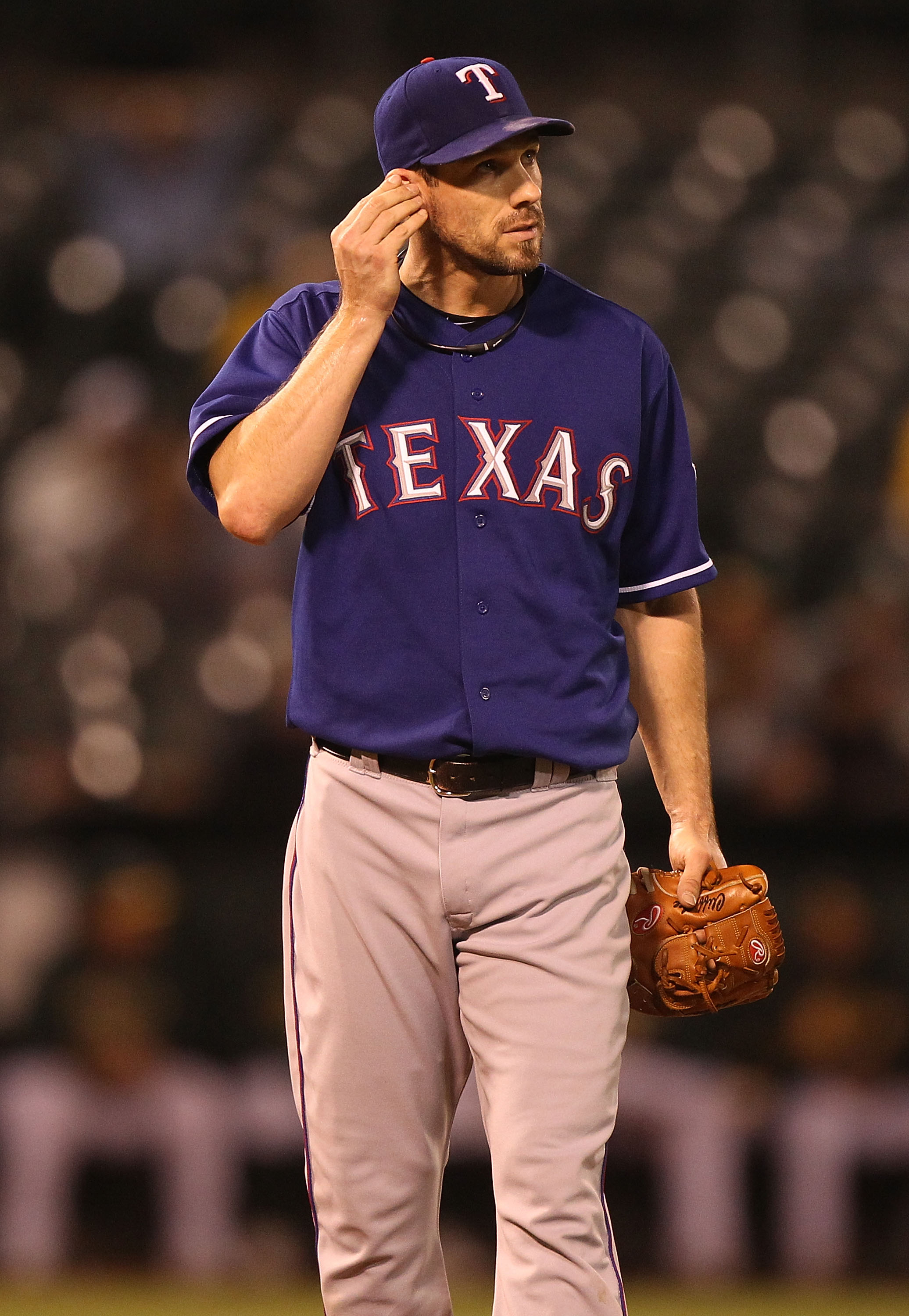 OAKLAND, CA - SEPTEMBER 23:  Cliff Lee #33 of the Texas Rangers holds his ear after a single by Jack Cust of the Oakland Athletics in the fourth inning during a Major League Baseball game at the Oakland-Alameda County Coliseum on September 23, 2010 in Oak