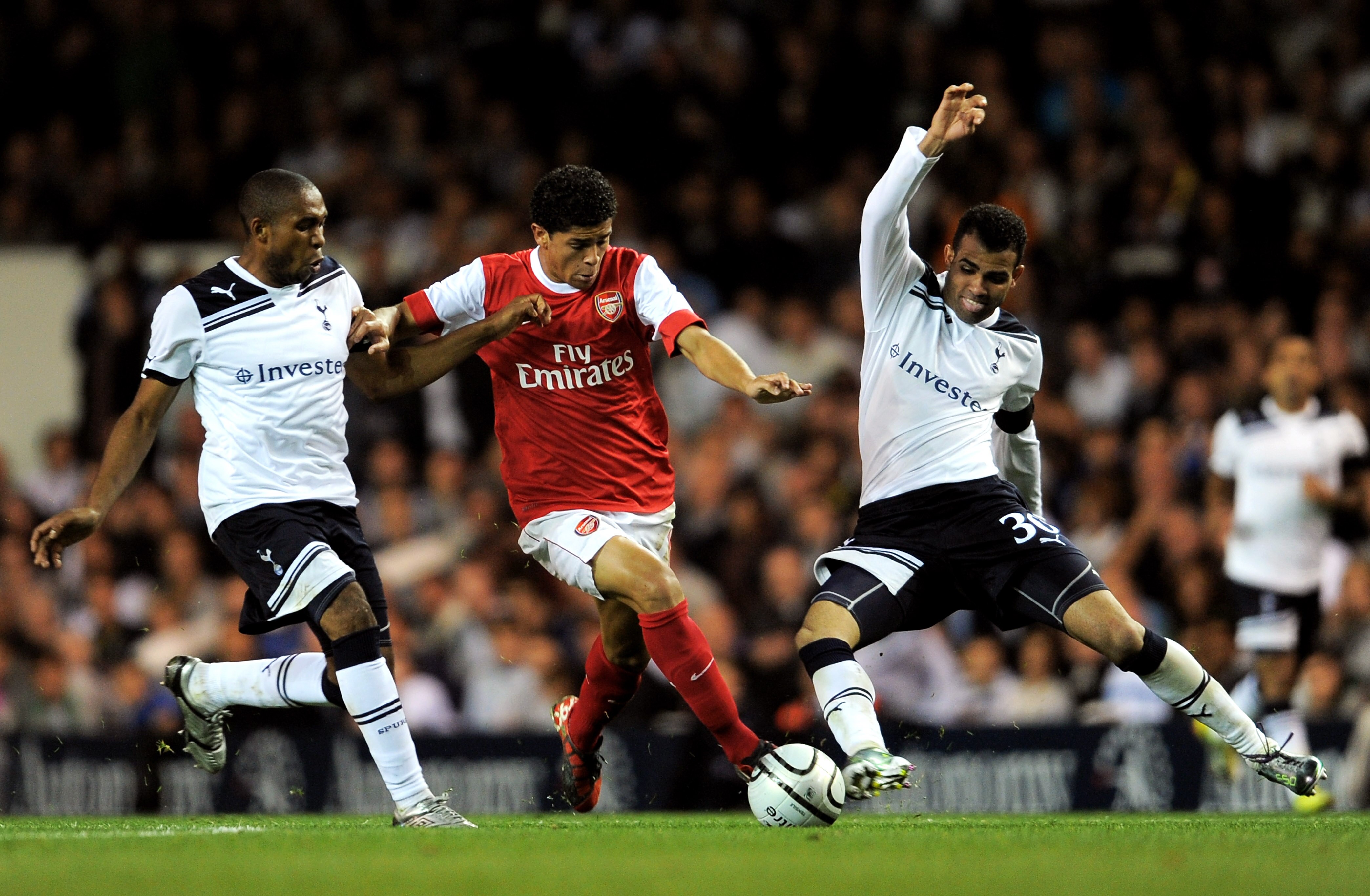 LONDON, ENGLAND - SEPTEMBER 21:  Denilson of Arsenal is tackled by Sandro (R) and Wilson Palacios (L) of Spurs during the Carling Cup third round match between Tottenham Hotspur and Arsenal at White Hart Lane on September 21, 2010 in London, England.  (Ph