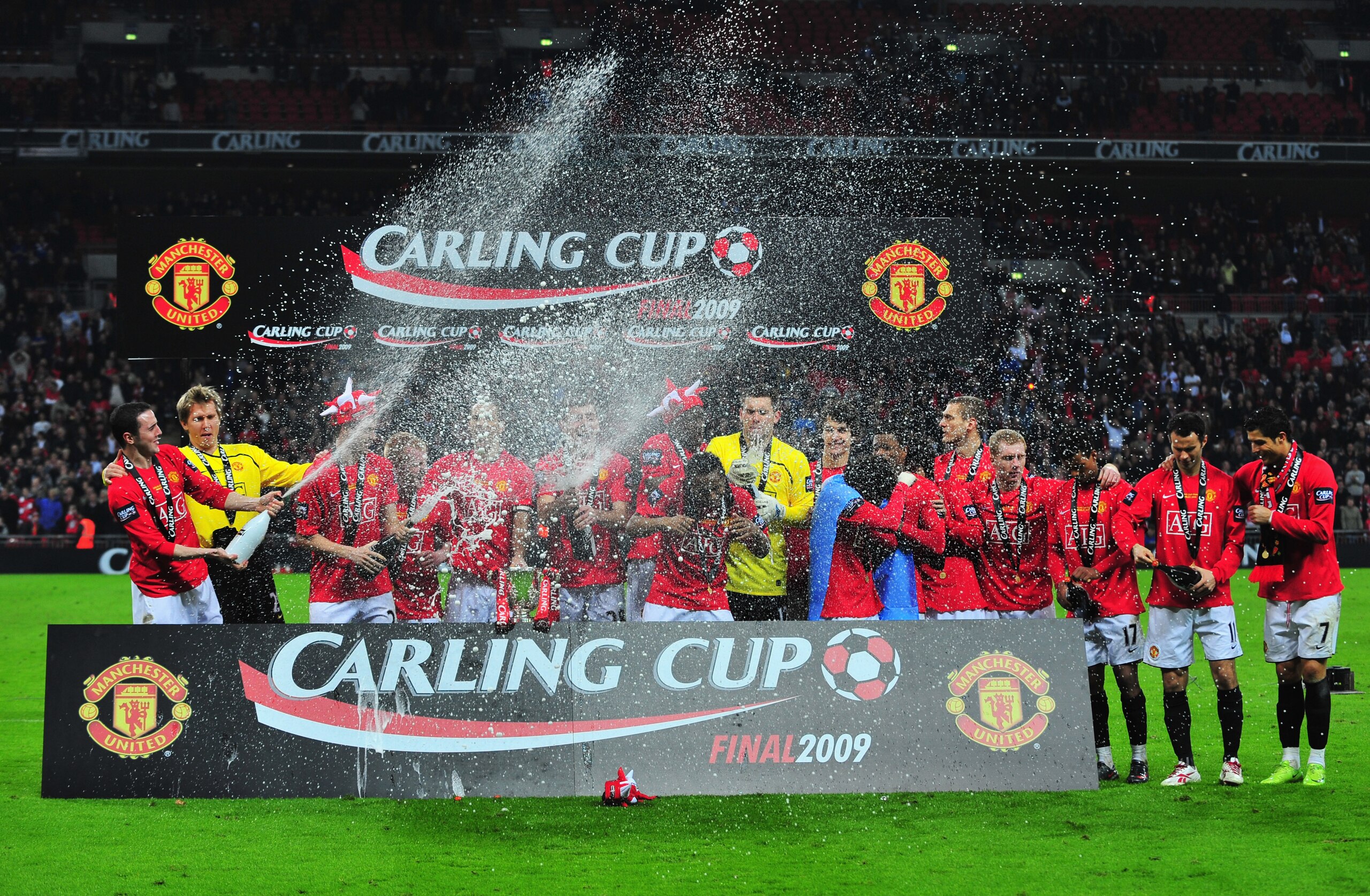 LONDON - MARCH 01:  Manchester United players celebrate with the trophy after victory during the Carling Cup Final match between Manchester United and Tottenham Hotspur at Wembley Stadium on March 1, 2009 in London, England.  (Photo by Mike Hewitt/Getty I