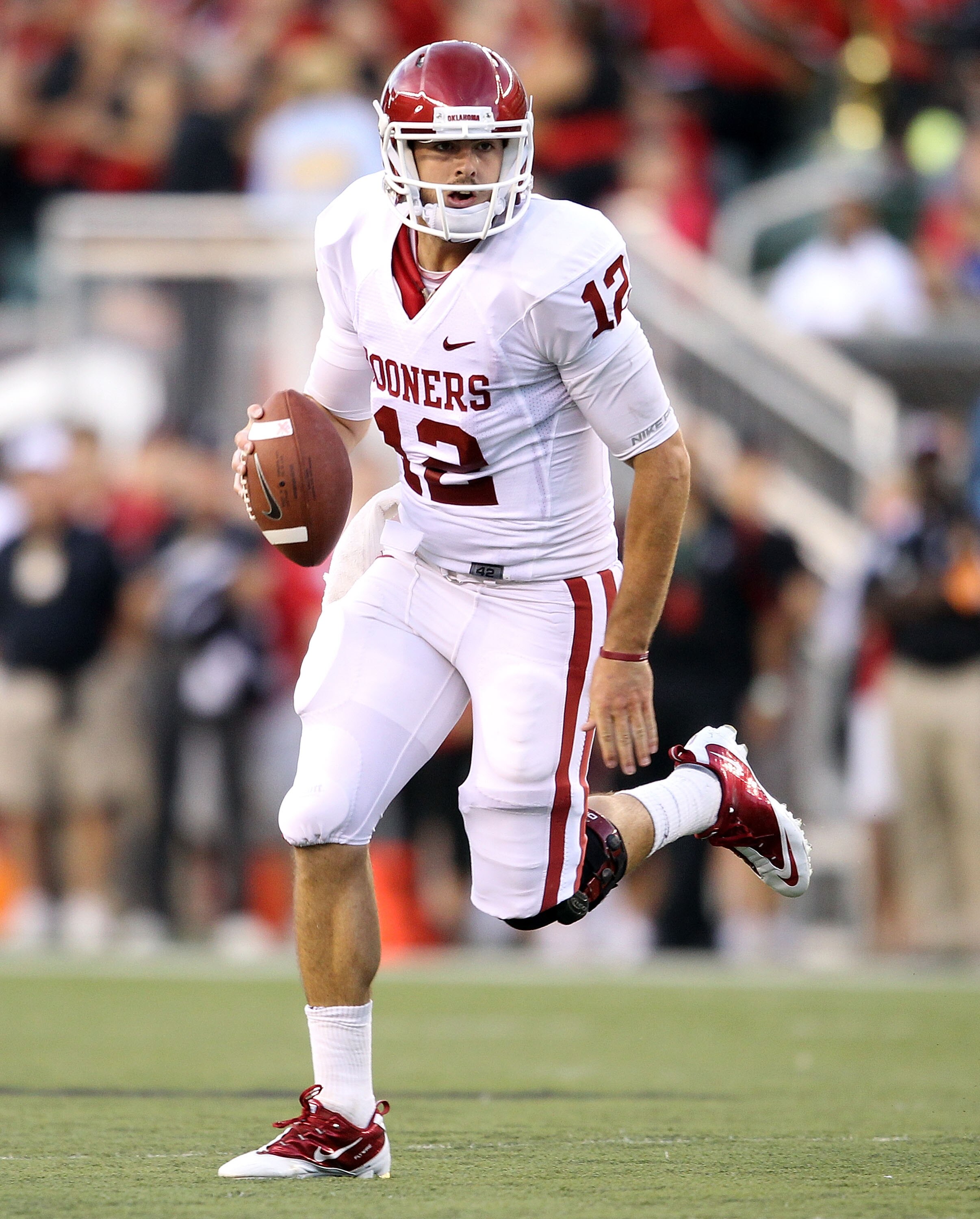 CINCINNATI - SEPTEMBER 25:  Landry Jones #12 of the Oklahoma Sooners runs with the ball during the game against the Cincinnati Bearcats at Paul Brown Stadium on September 25, 2010 in Cincinnati, Ohio.  (Photo by Andy Lyons/Getty Images)