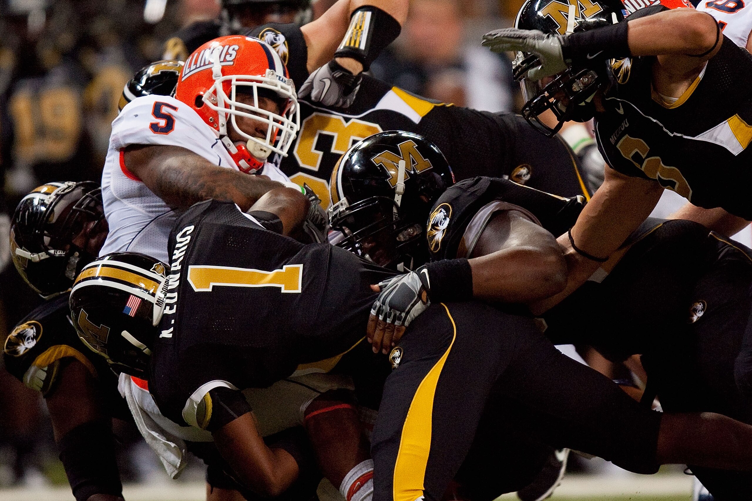 ST. LOUIS - SEPTEMBER 4: Mikel Leshoure #5 of the University of Illinois Fighting Illini is tackled against the University of Missouri Tigers during the State Farm Arch Rivalry game on September 4, 2010 at the Edward Jones Dome in St. Louis, Missouri. The