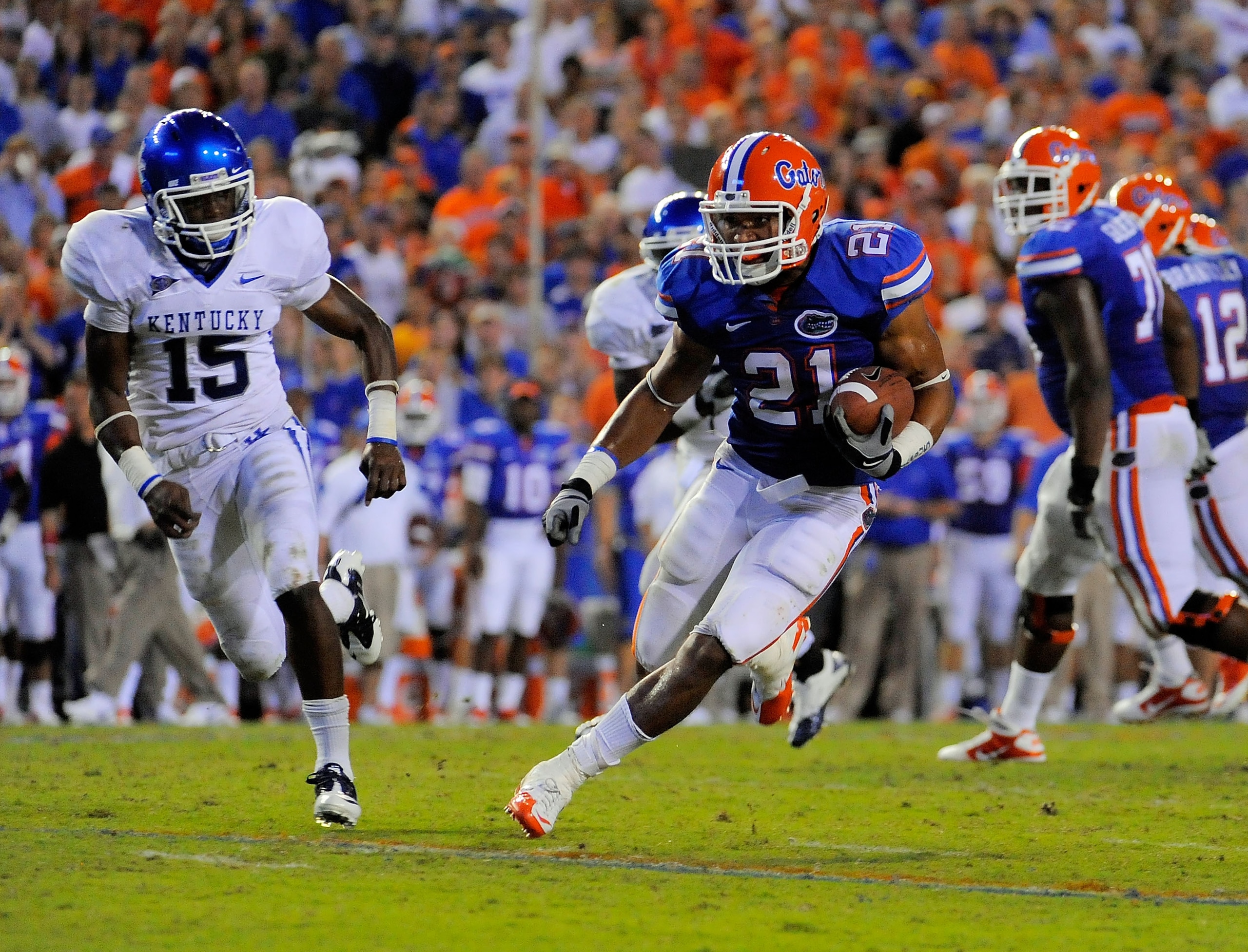 GAINESVILLE, FL - SEPTEMBER 25:  Running back Emmanuel Moody #21 of the Florida Gators gets past cornerback Martavius Neloms #15 of the Kentucky Wildcats at Ben Hill Griffin Stadium on September 25, 2010 in Gainesville, Florida. Florida defeated Kentucky