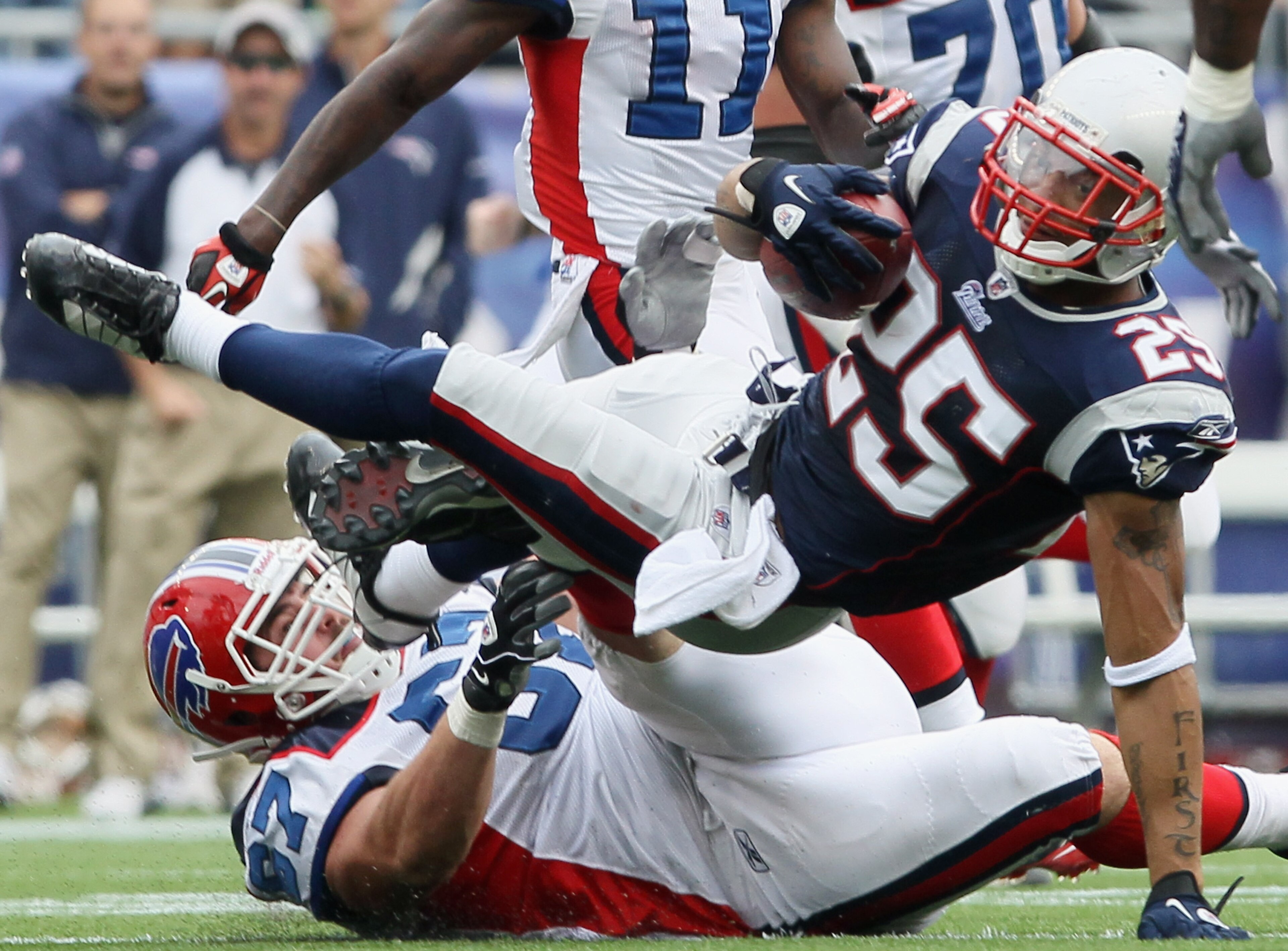 FOXBORO, MA - SEPTEMBER 26:  Patrick Chung #25 of the New England Patriots is tackled by Andy Levitre #67  of the Buffalo Bills after Chung intercepted a pass from Ryan Fitzpatrick of the Bills during on September 26, 2010 at Gillette Stadium in Foxboro, 