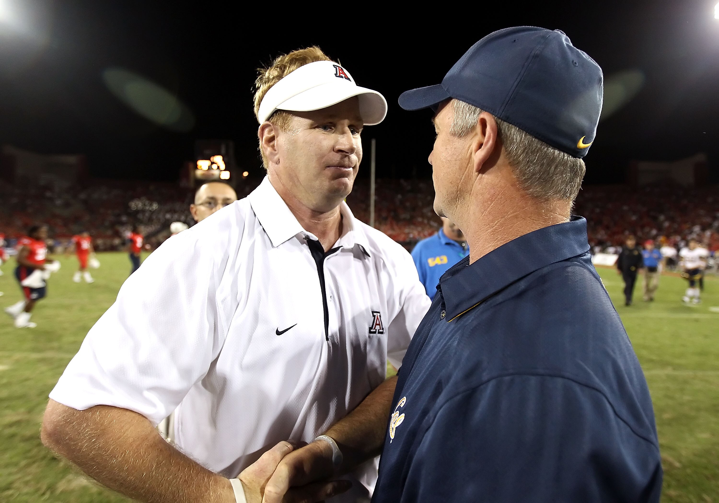 TUCSON, AZ - SEPTEMBER 25:  Head coach Mike Stoops of the Arizona Wildcats greets Jeff Tedford of the California Golden Bears following the college football game at Arizona Stadium on September 25, 2010 in Tucson, Arizona.  The Wildcats defeated the Golde