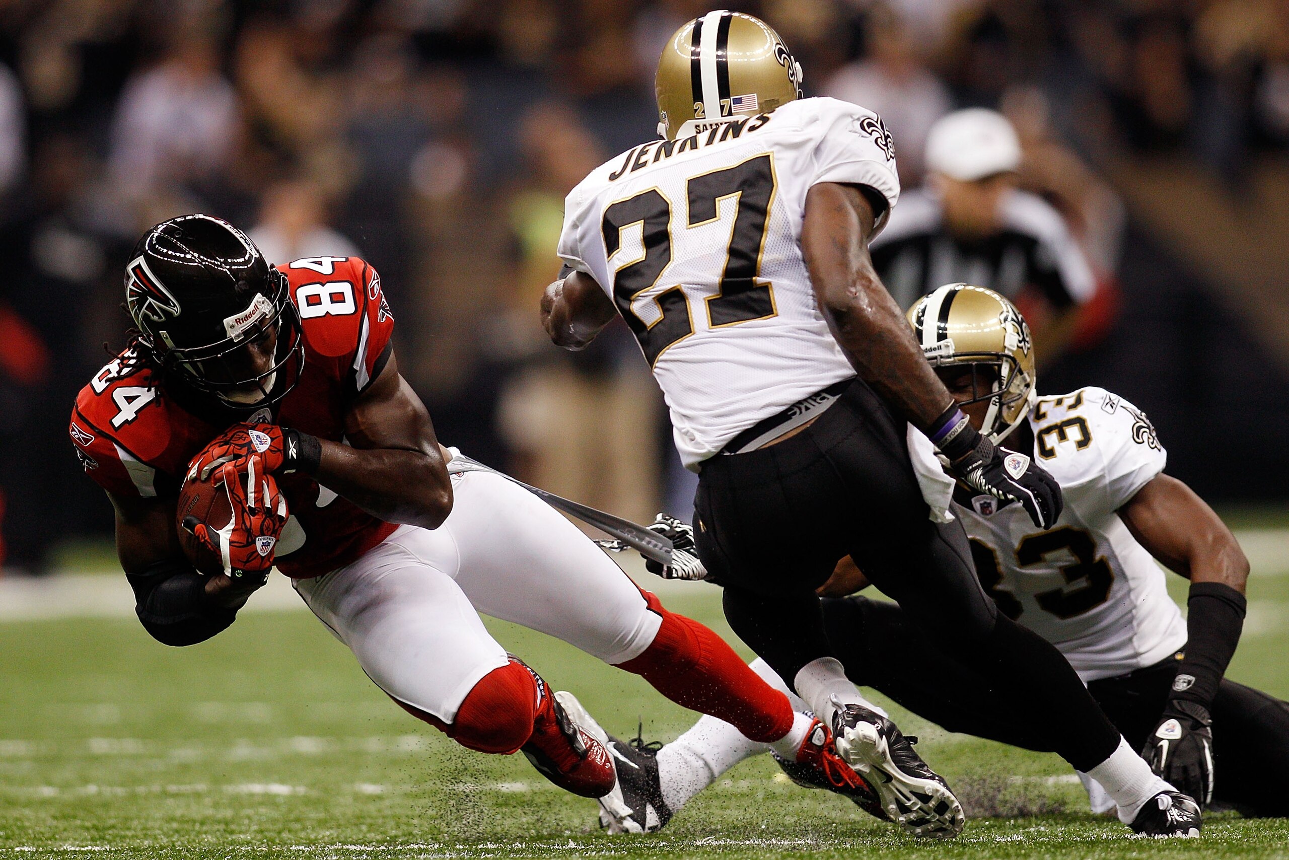 NEW ORLEANS - SEPTEMBER 26:  Roddy White #84 of the Atlanta Falcons is tackled by Malcom Jenkins #27 of the New Orleans Saints at the Louisiana Superdome on September 26, 2010 in New Orleans, Louisiana.  The Falcons defeated the Saints 27-24.  (Photo by C