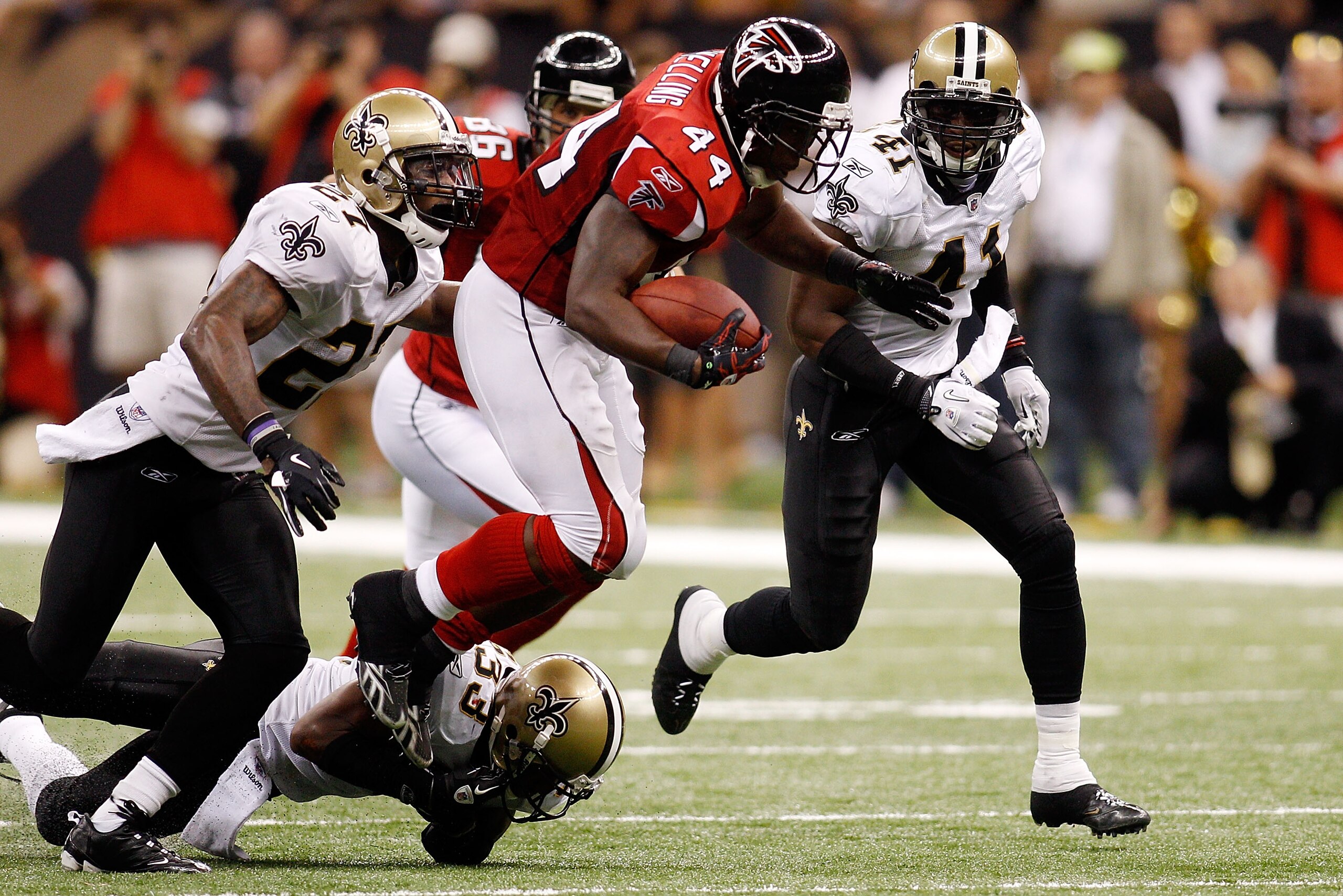 NEW ORLEANS - SEPTEMBER 26:  Jason Snelling #44 of the Atlanta Falcons is tripped by Jabari Greer #33 of th New Orleans Saints at the Louisiana Superdome on September 26, 2010 in New Orleans, Louisiana.  The Falcons defeated the Saints 27-24.  (Photo by C