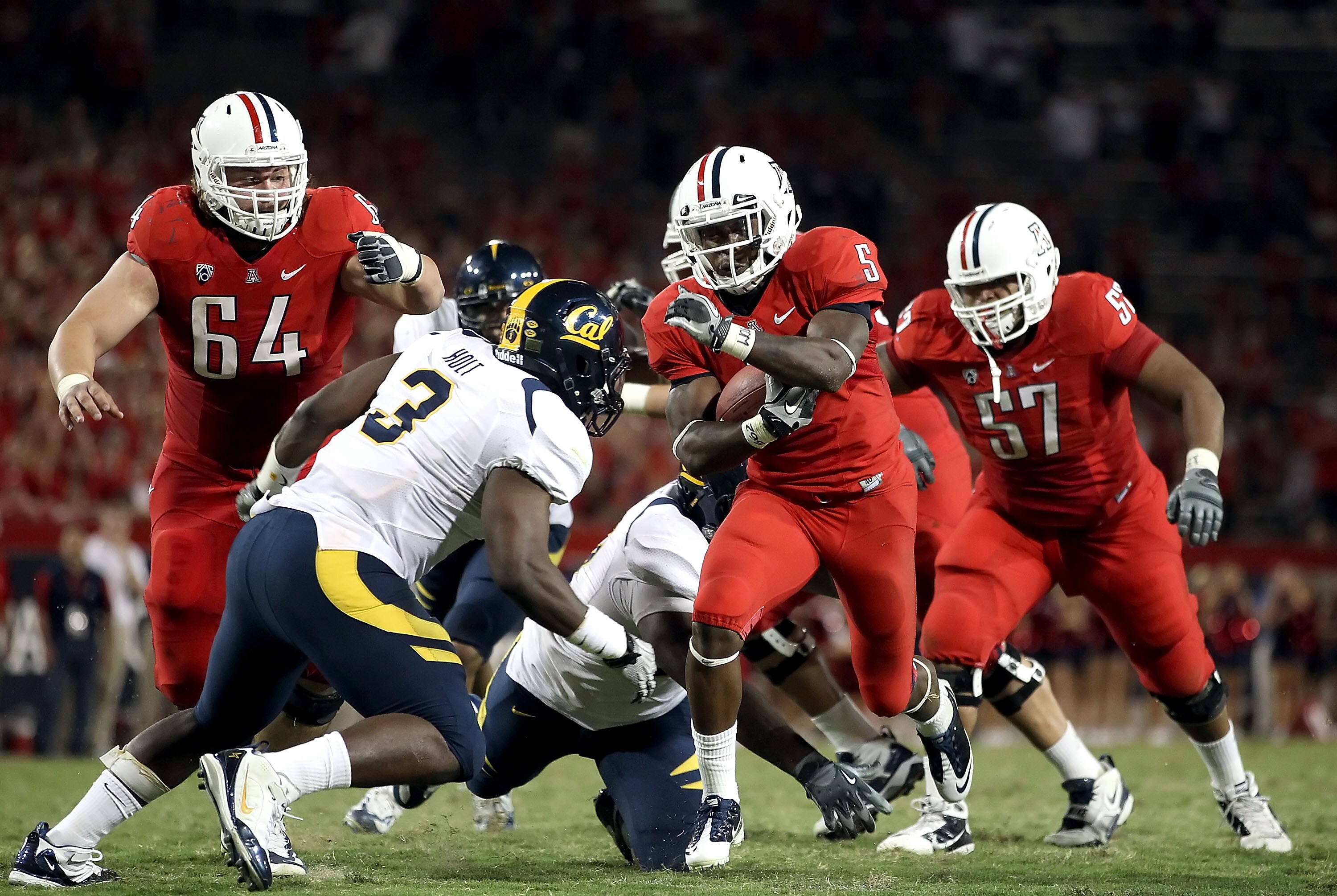 TUCSON, AZ - SEPTEMBER 25:  Runningback Nic Grigsby #5 of the Arizona Wildcats rushes the football for 6 yards during the fourth quarter of the college football game against the California Golden Bears at Arizona Stadium on September 25, 2010 in Tucson, A
