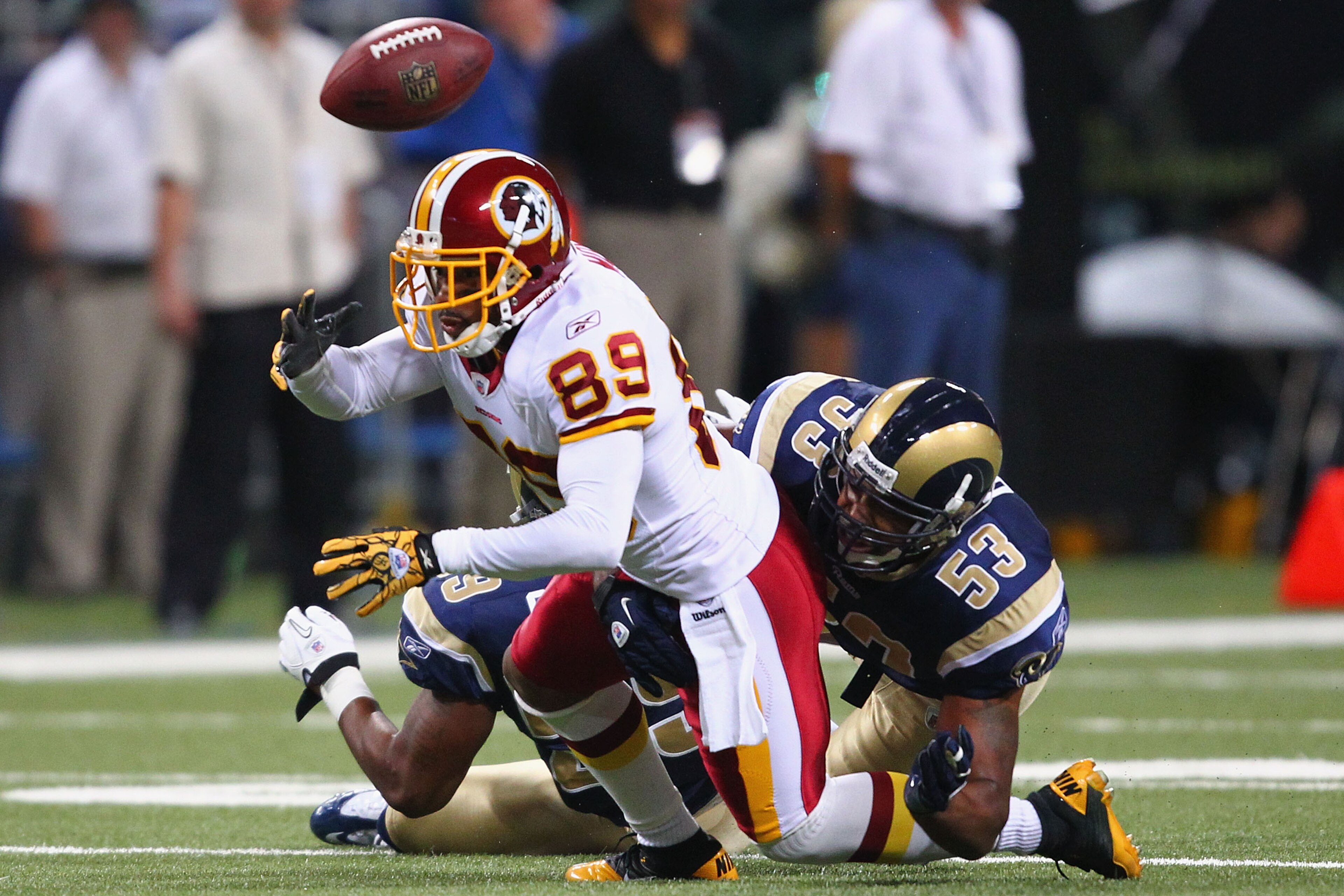 ST. LOUIS - SEPTEMBER 26: Na'Il Diggs #53 of the St. Louis Rams forces a fumble against Santana Moss #89 of the Washington Redskins at the Edward Jones Dome on September 26, 2010 in St. Louis, Missouri.  The Rams beat the Redskins 30-16.  (Photo by Dilip