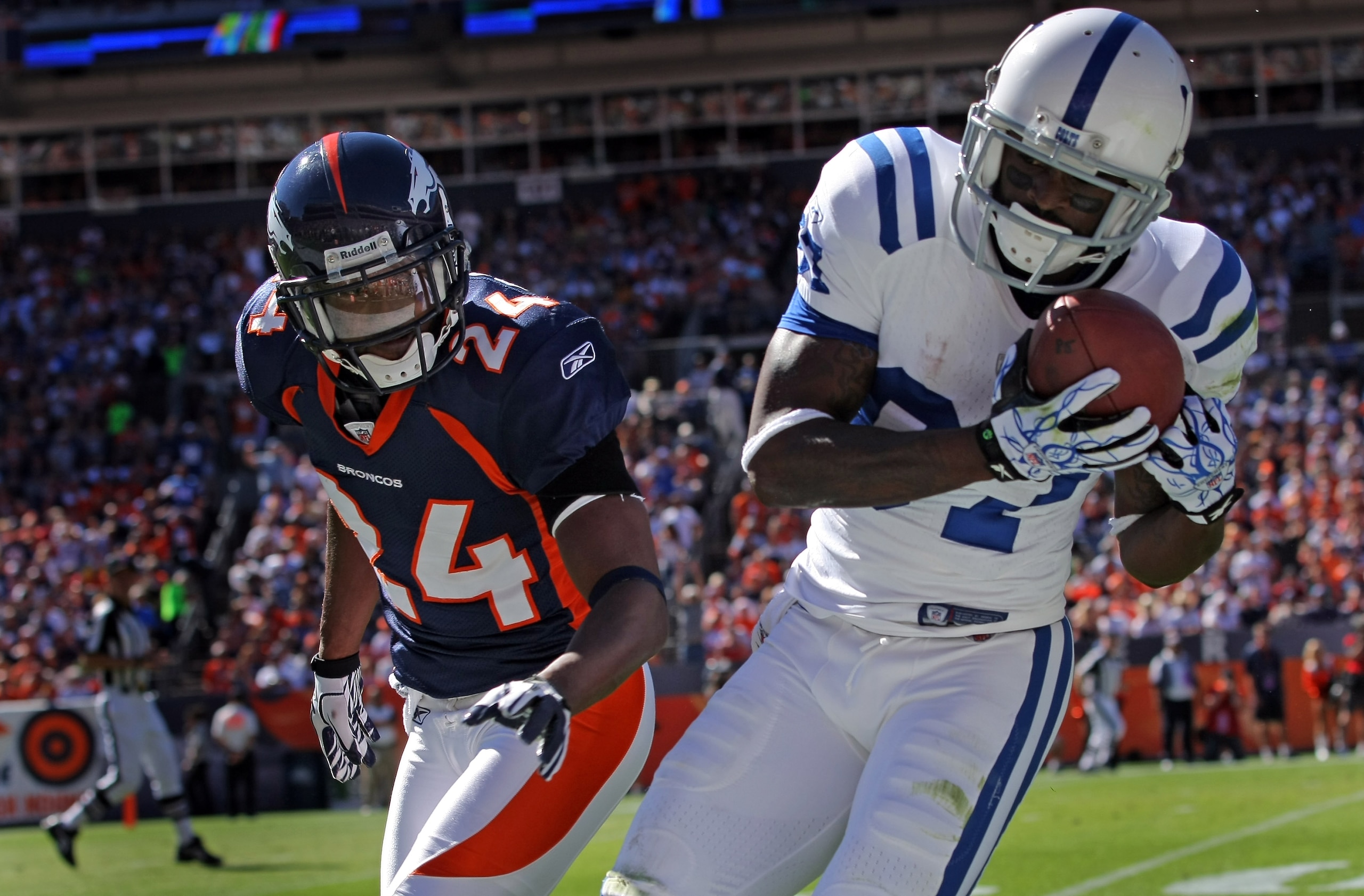 DENVER - SEPTEMBER 26: Wide receiver Reggie Wayne #87 of the Indianapolis Colts makes a first down reception as Champ Bailey #24 of the Denver Broncos defends at INVESCO Field at Mile High on September 26, 2010 in Denver, Colorado. The Colts defeated the DENVER - SEPTEMBER 26: Wide receiver Reggie Wayne #87 of the Indianapolis Colts makes a first down reception as Champ Bailey #24 of the Denver Broncos defends at INVESCO Field at Mile High on September 26, 2010 in Denver, Colorado. The Colts defeated the