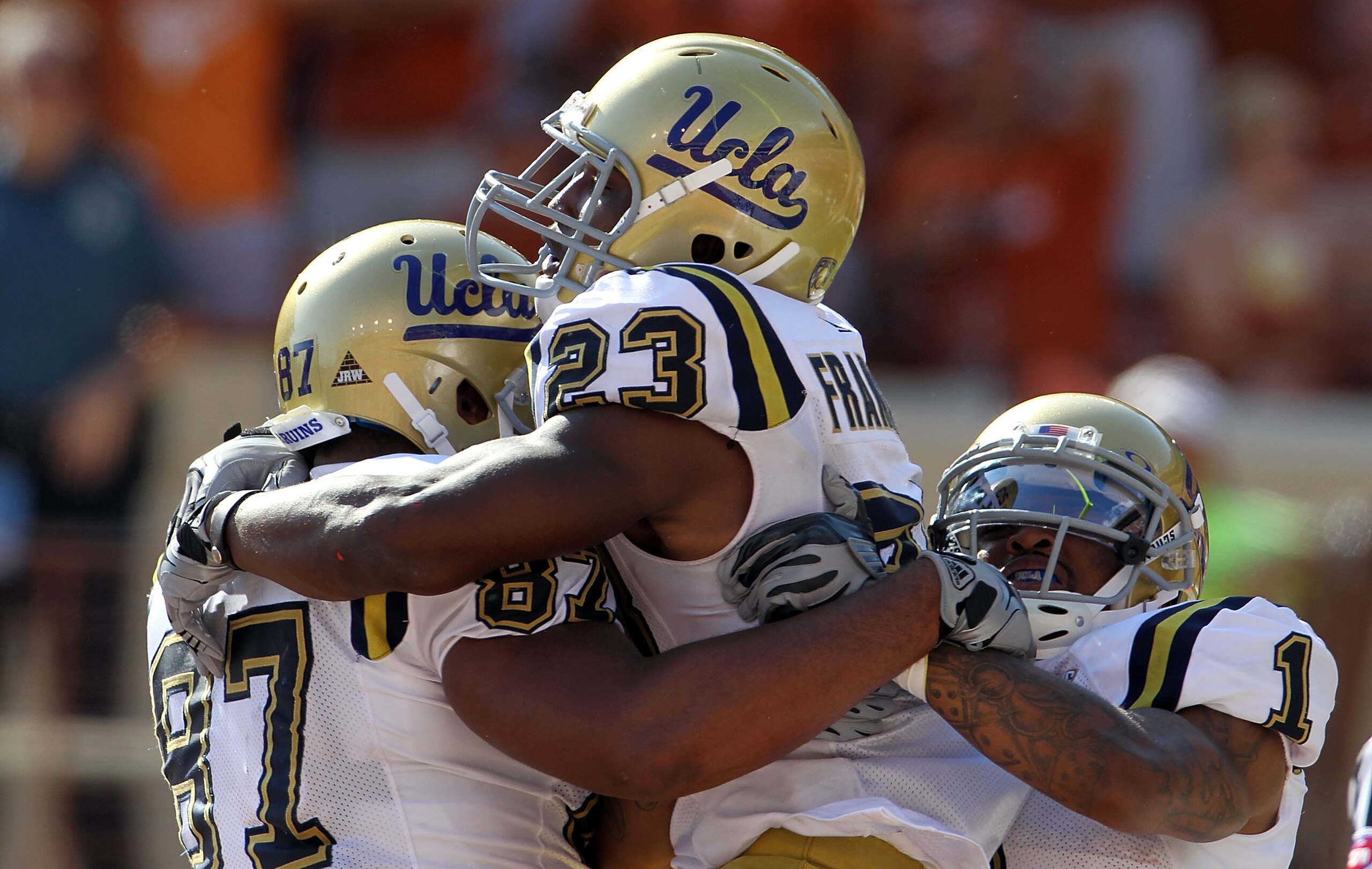 AUSTIN, TX - SEPTEMBER 25:  Tailback Johnathan Franklin #23 of the UCLA Bruins celebrates a touchdown with Cory Harkey #87 and Randall Carroll #1 in the third quarter against the Texas Longhorns at Darrell K Royal-Texas Memorial Stadium on September 25, 2
