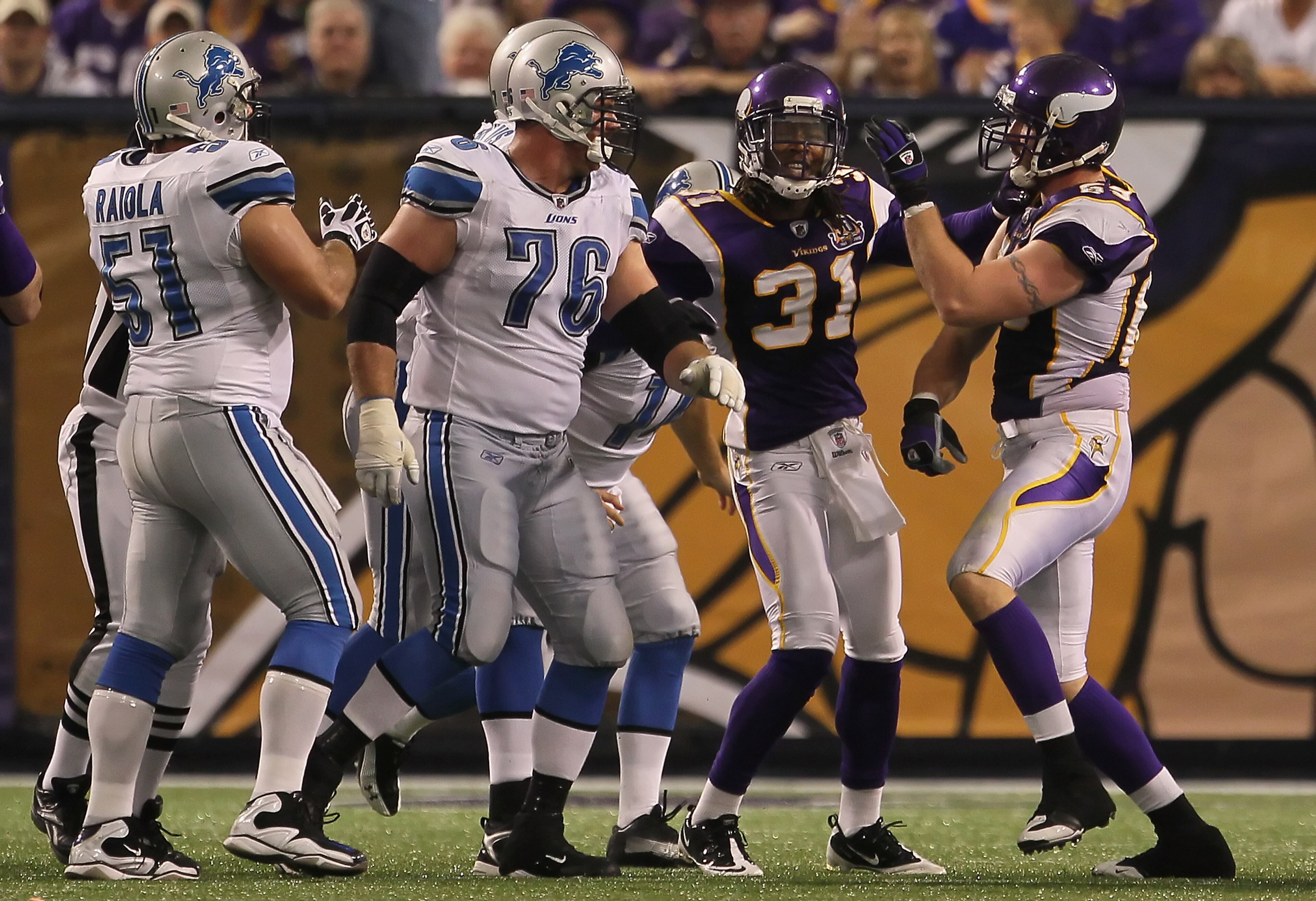 MINNEAPOLIS - SEPTEMBER 26:  Chris Cook #31 of the Minnesota Vikings breaks up a fight between Jeff Backus #76 of the Detroit Lions and Jared Allen #69 of the Vikings during the second half at Hubert H. Humphrey Metrodome on September 26, 2010 in Minneapo