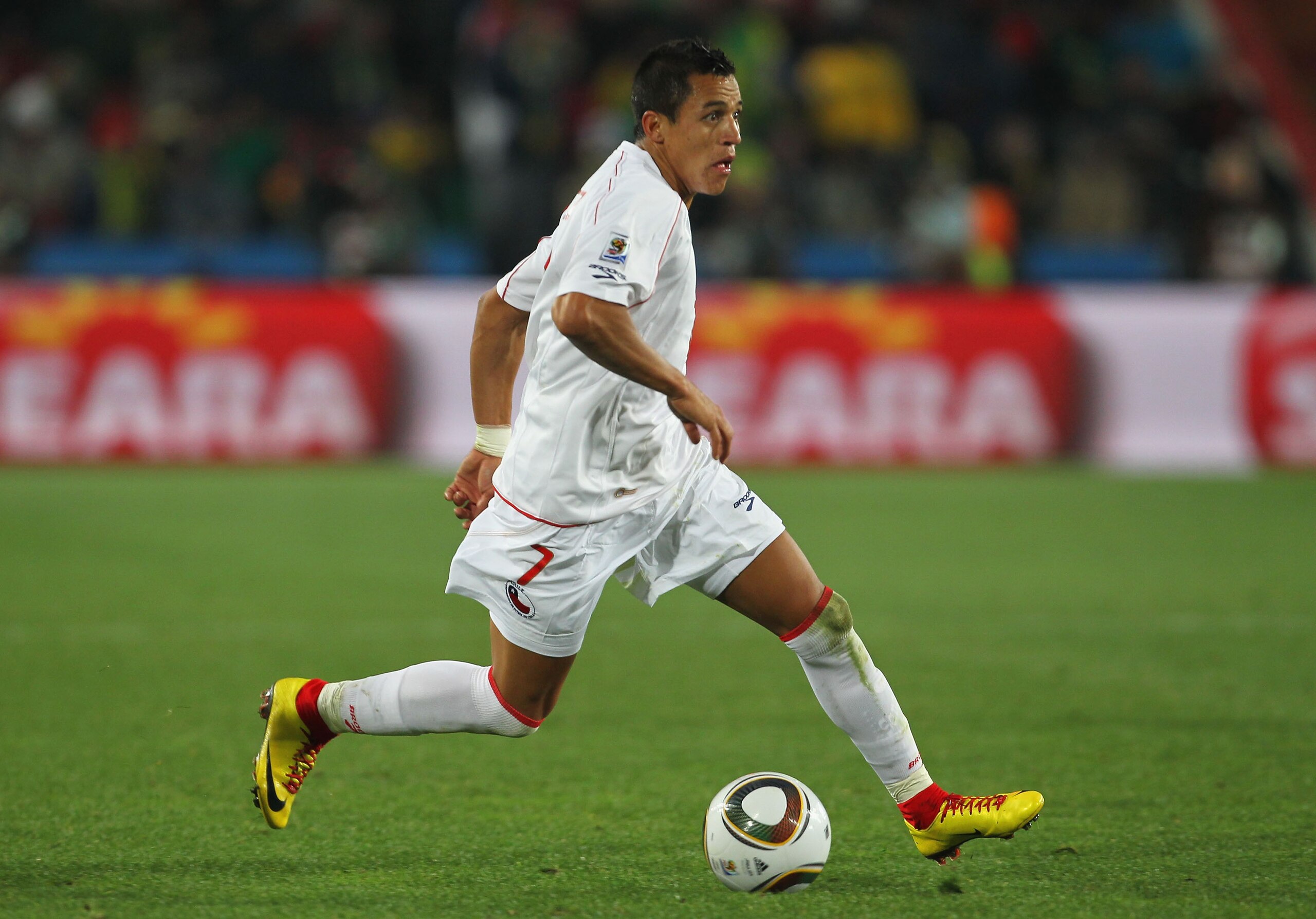 JOHANNESBURG, SOUTH AFRICA - JUNE 28:  Alexis Sanchez of Chile runs with the ball during the 2010 FIFA World Cup South Africa Round of Sixteen match between Brazil and Chile at Ellis Park Stadium on June 28, 2010 in Johannesburg, South Africa.  (Photo by 