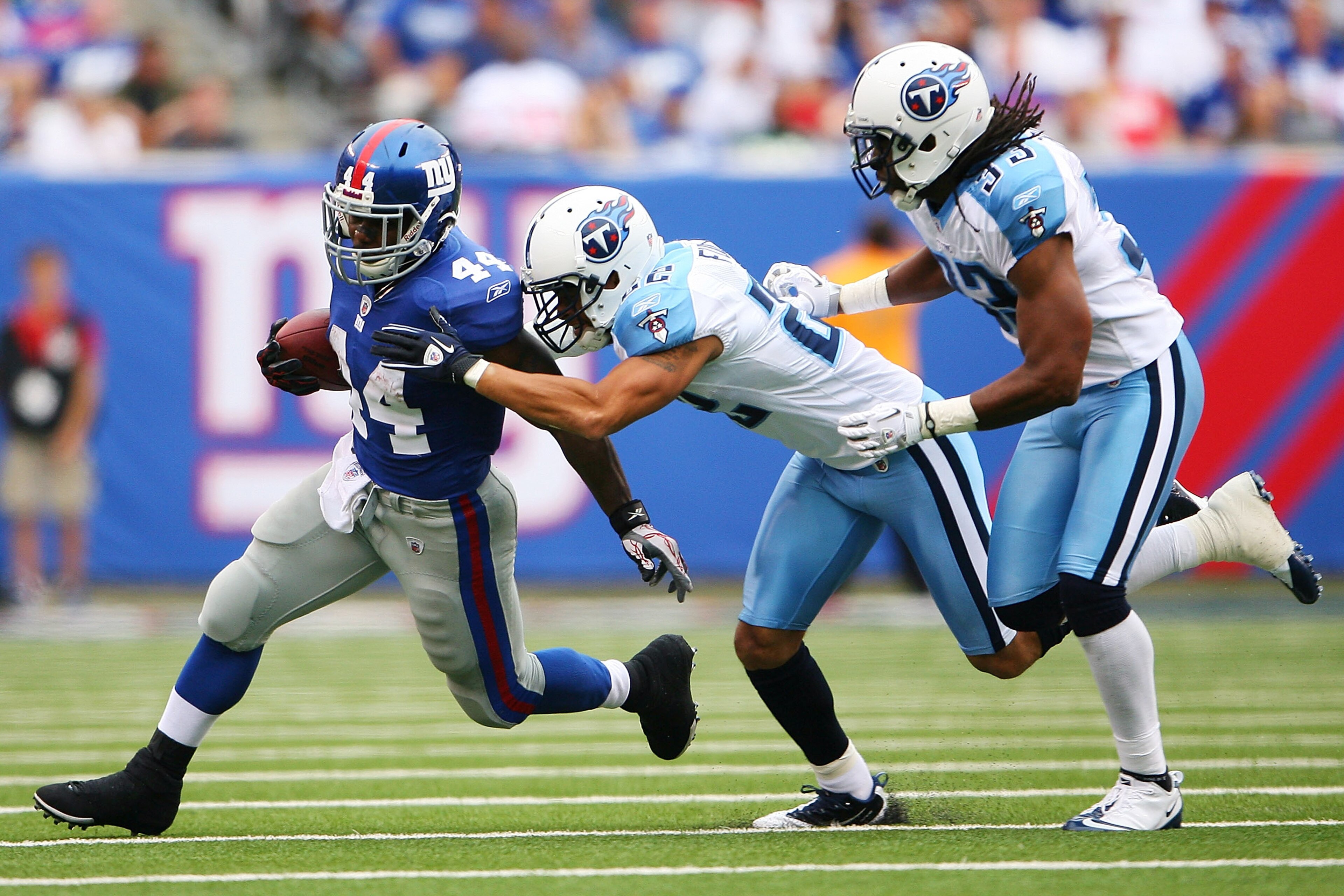 EAST RUTHERFORD, NJ - SEPTEMBER 26: (L-R) Ahmad Bradshaw #44 of the New York Giants runs the ball against Vincent Fuller #22 and Michael Griffin #33 of the Tennessee Titans at New Meadowlands Stadium on September 26, 2010 in East Rutherford, New Jersey.