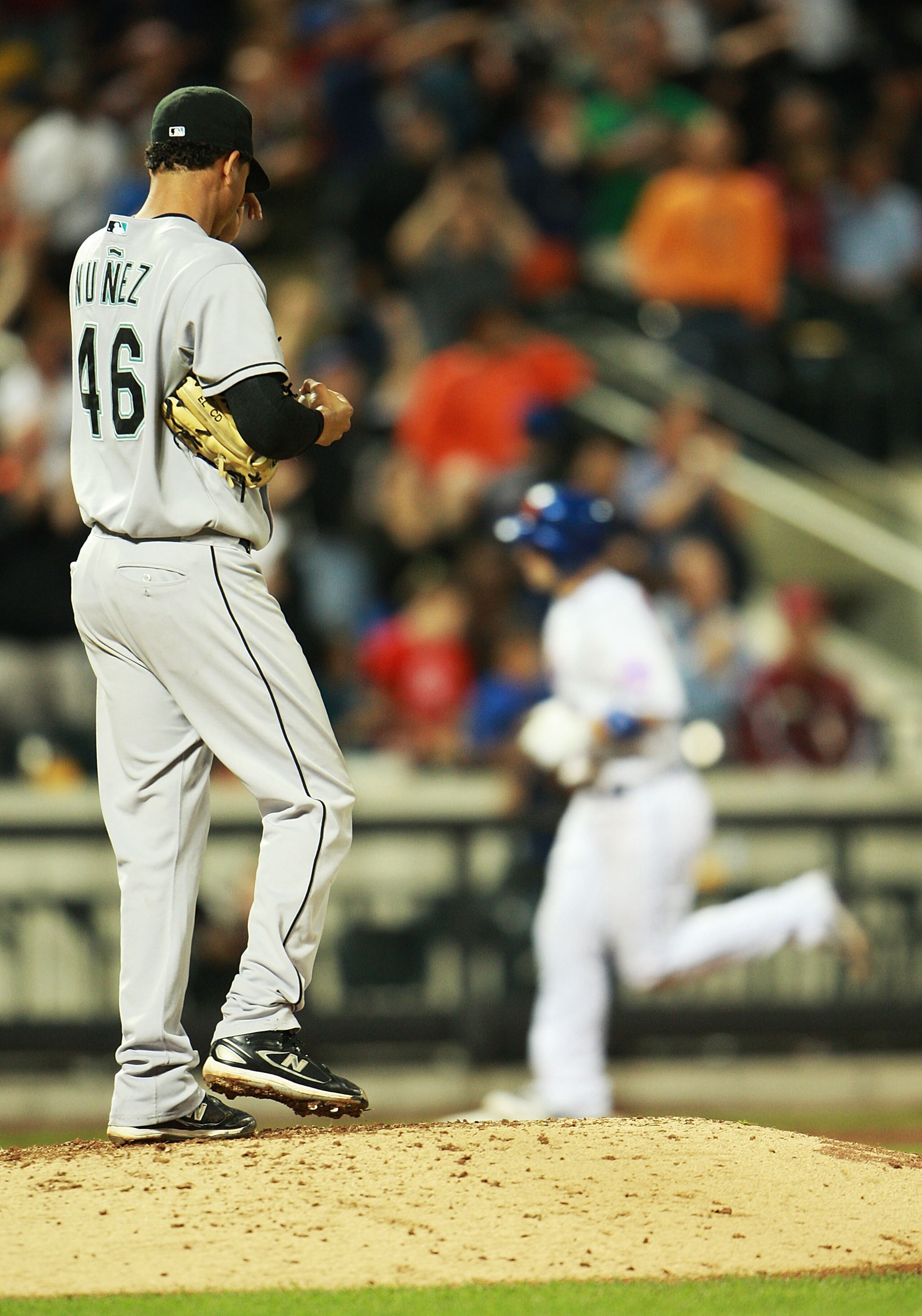 NEW YORK - AUGUST 25:  Leo Nunez #46 of the Florida Marlins walks back to the mound after allowing a home run from David Wright #5 (background) of the New York Mets in the ninth inning on August 25, 2010 at Citi Field in the Flushing neighborhood of the Q