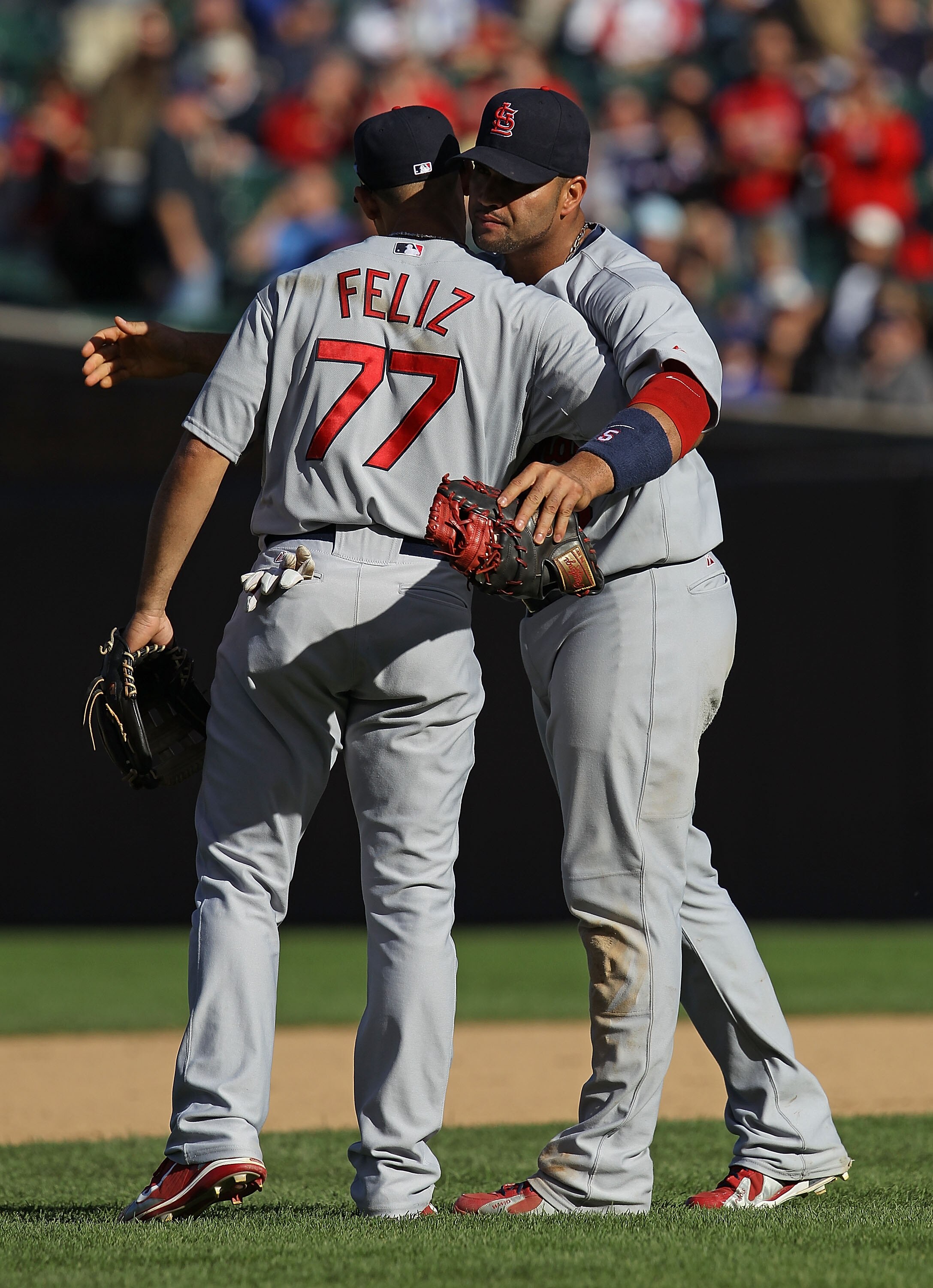 CHICAGO - SEPTEMBER 24: Albert Pujols #5 of the St. Louis Cardinals hugs teammate Pedro Feliz #77 after a win over the Chicago Cubs at Wrigley Field on September 24, 2010 in Chicago, Illinois. The Cardinals defeated the Cubs 7-1. (Photo by Jonathan Daniel