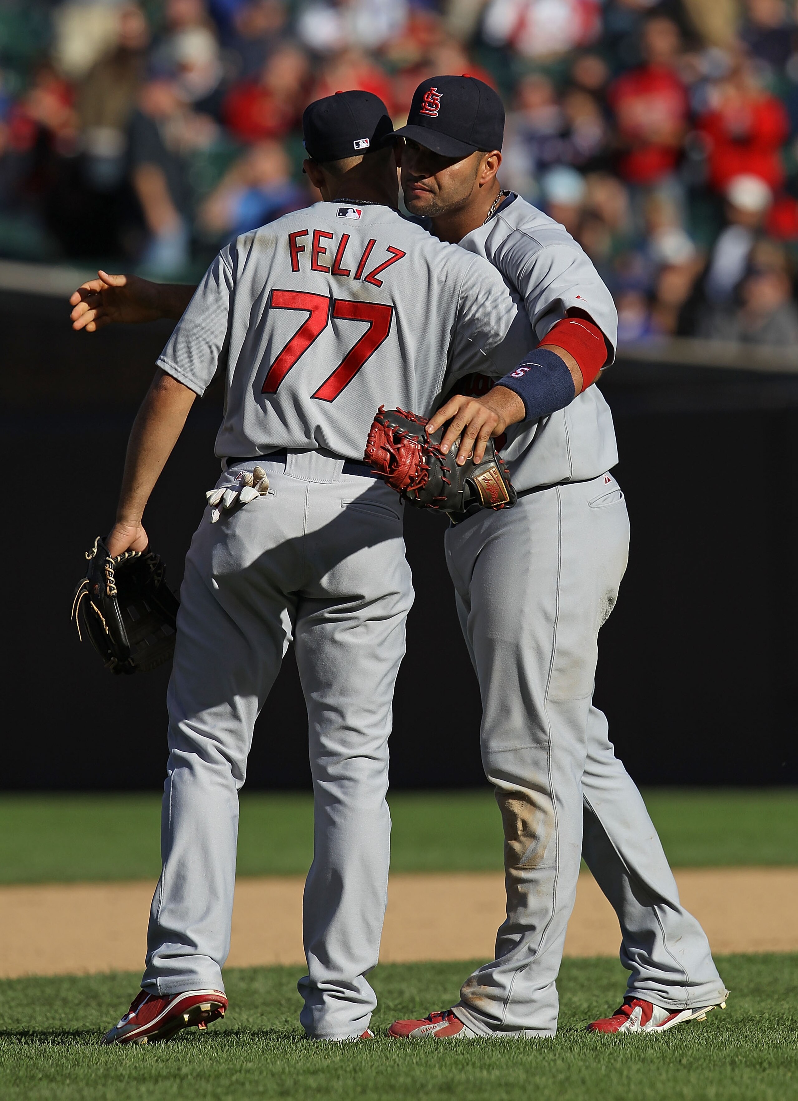 CHICAGO - SEPTEMBER 24: Albert Pujols #5 of the St. Louis Cardinals hugs teammate Pedro Feliz #77 after a win over the Chicago Cubs at Wrigley Field on September 24, 2010 in Chicago, Illinois. The Cardinals defeated the Cubs 7-1. (Photo by Jonathan Daniel