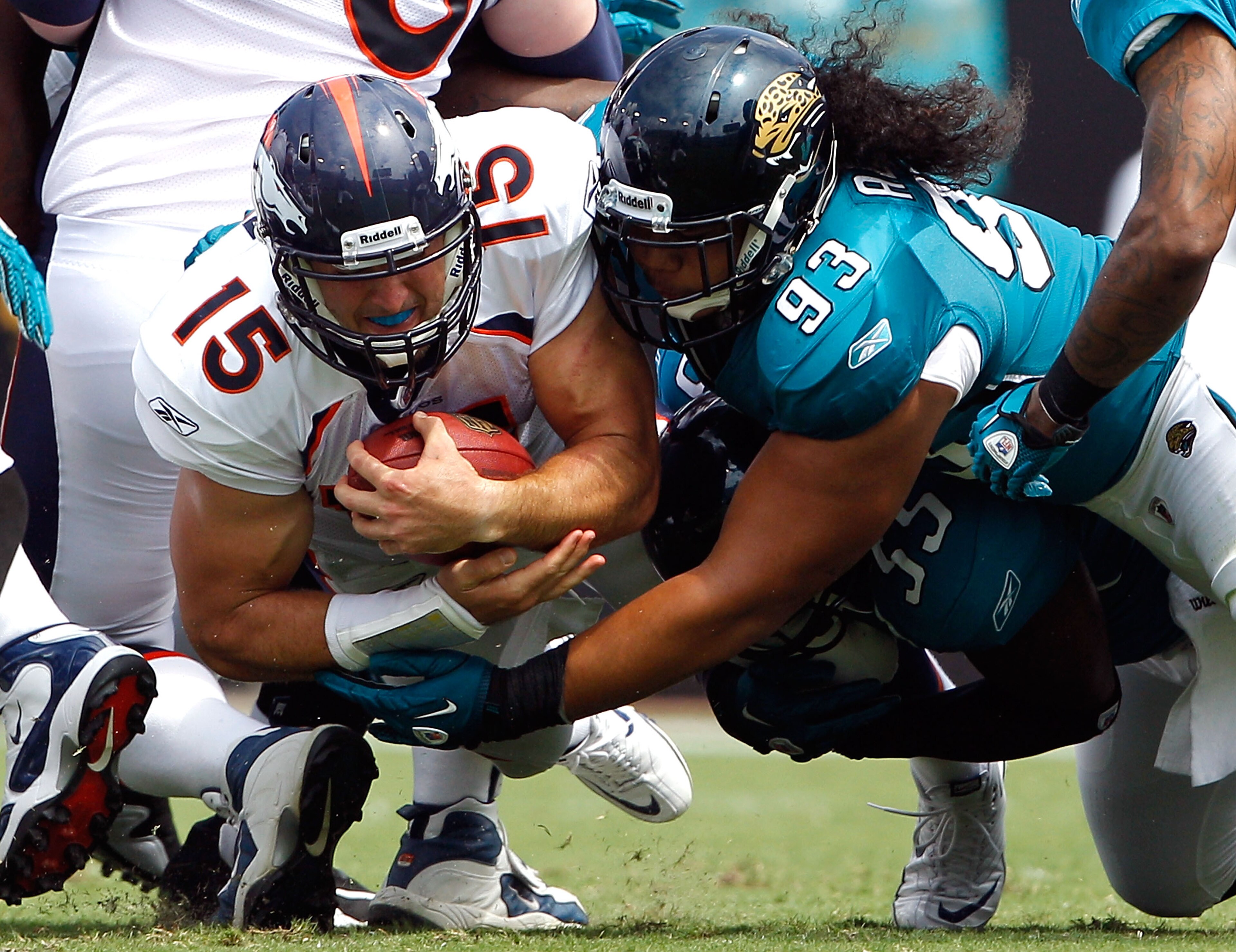 JACKSONVILLE, FL - SEPTEMBER 12:  Tyson Alualu #93 of the Jacksonville Jaguars tackles Tim Tebow #15 of the Denver Broncos during the NFL season opener game at EverBank Field on September 12, 2010 in Jacksonville, Florida.  (Photo by Sam Greenwood/Getty I