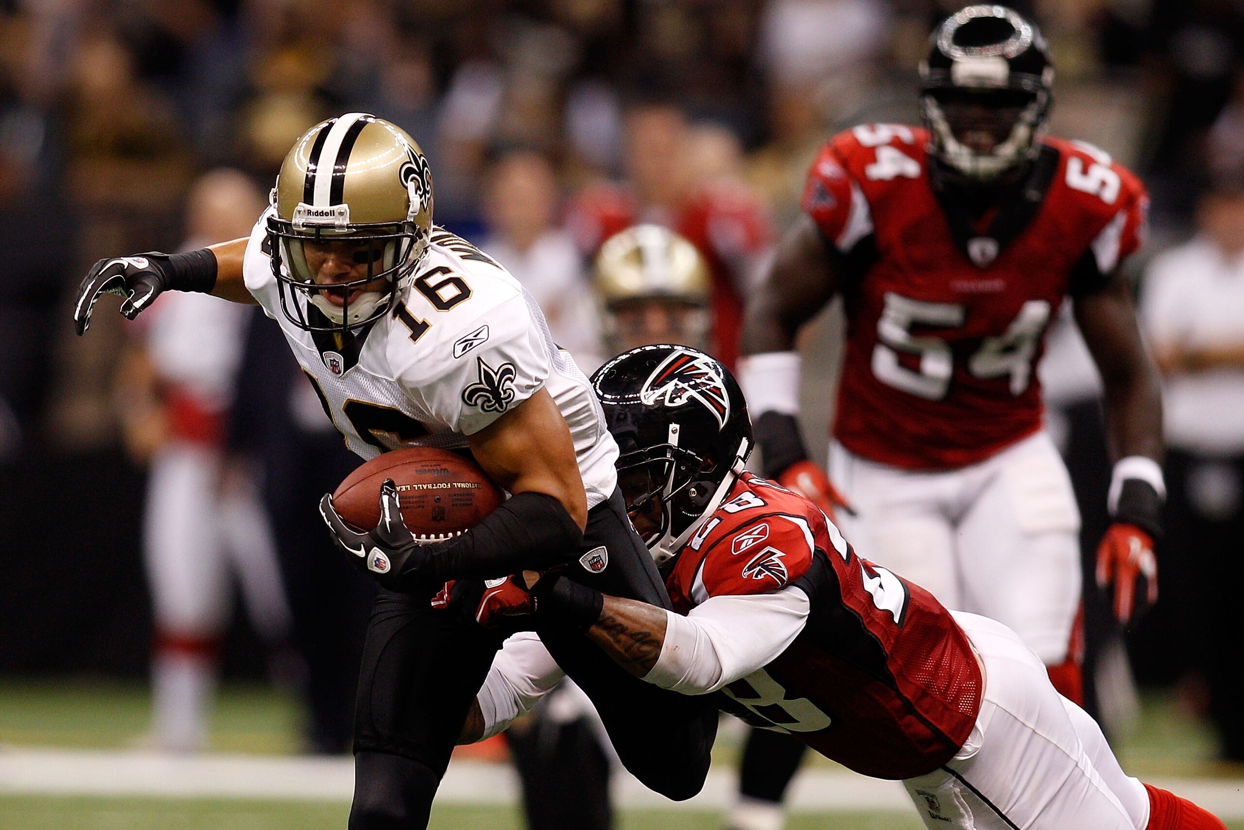 NEW ORLEANS - SEPTEMBER 26: Lance Moore #16 of the New Orleans Saints is tackled by Thomas DeCoud #28 of the Atlanta Falcons at the Louisiana Superdome on September 26, 2010 in New Orleans, Louisiana. The Falcons defeated the Saints 27-24. (Photo by Ch NEW ORLEANS - SEPTEMBER 26: Lance Moore #16 of the New Orleans Saints is tackled by Thomas DeCoud #28 of the Atlanta Falcons at the Louisiana Superdome on September 26, 2010 in New Orleans, Louisiana. The Falcons defeated the Saints 27-24. (Photo by Ch