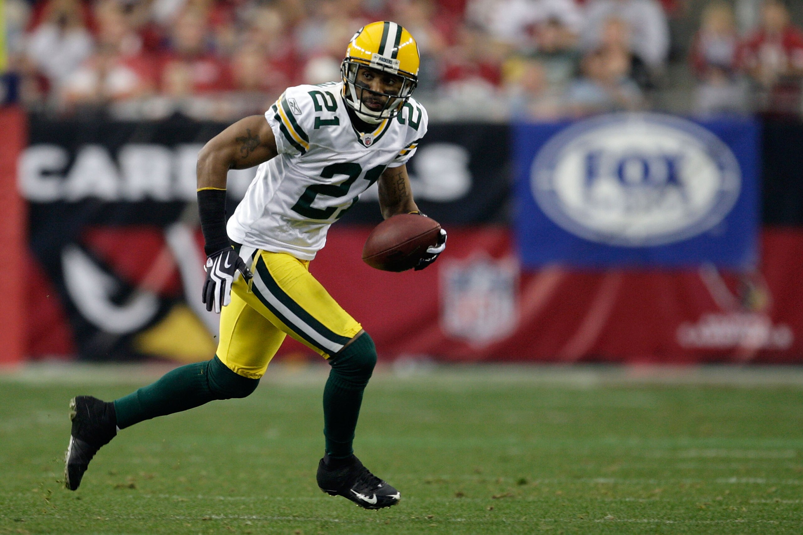 GLENDALE, AZ - JANUARY 03:  Charles Woodson #21 of the Green Bay Packers runs for a 45-yard interception return for a touchdown against the Arizona Cardinals in the second quarter at University of Phoenix Stadium on January 3, 2010 in Glendale, Arizona.