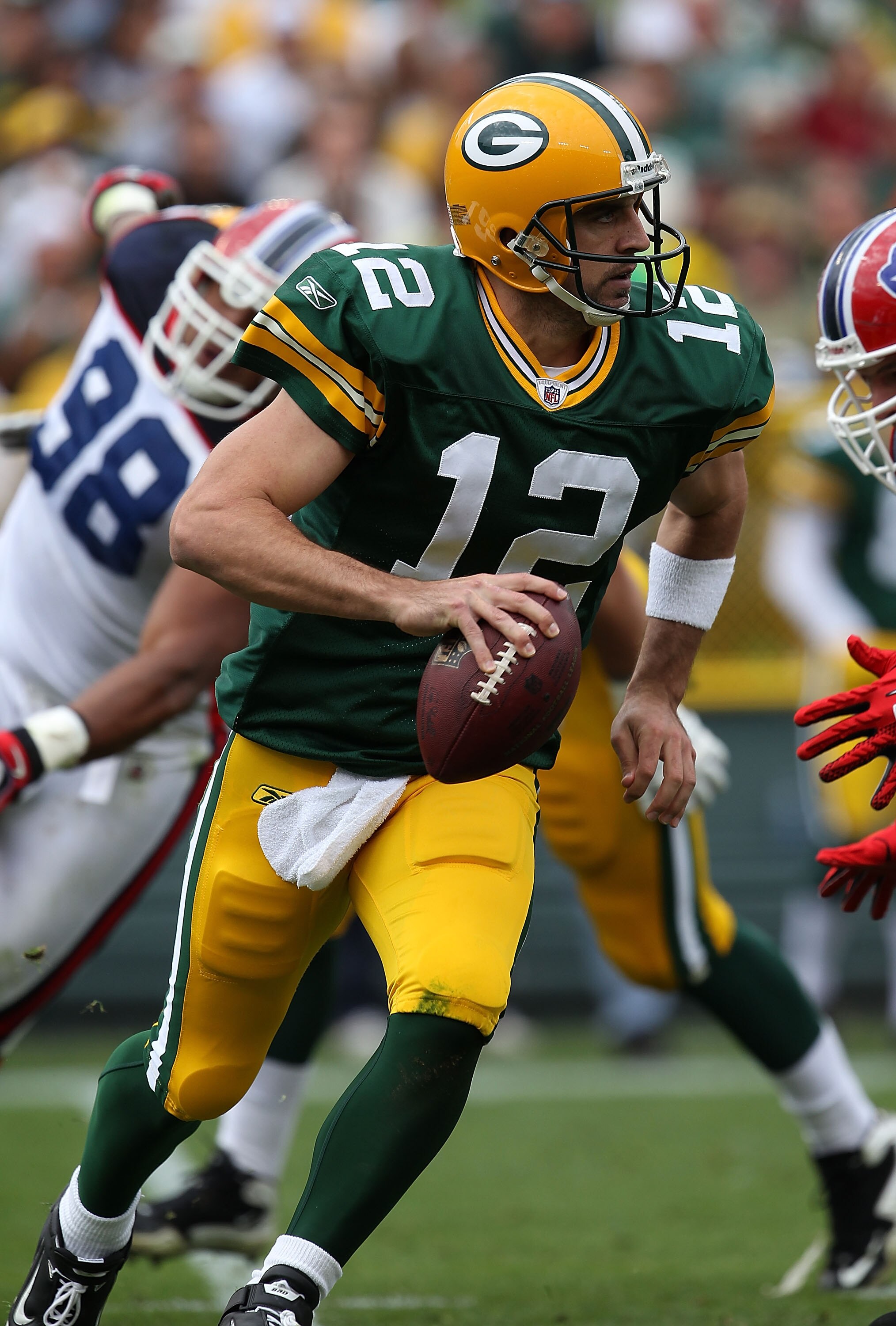GREEN BAY, WI - SEPTEMBER 19: Aaron Rodgers #12 of the Green Bay Packers rolls out to look for a receiver against the Buffalo Bills at Lambeau Field on September 19, 2010 in Green Bay, Wisconsin. The Packers defeated the Bills 34-7. (Photo by Jonathan Dan GREEN BAY, WI - SEPTEMBER 19: Aaron Rodgers #12 of the Green Bay Packers rolls out to look for a receiver against the Buffalo Bills at Lambeau Field on September 19, 2010 in Green Bay, Wisconsin. The Packers defeated the Bills 34-7. (Photo by Jonathan Dan
