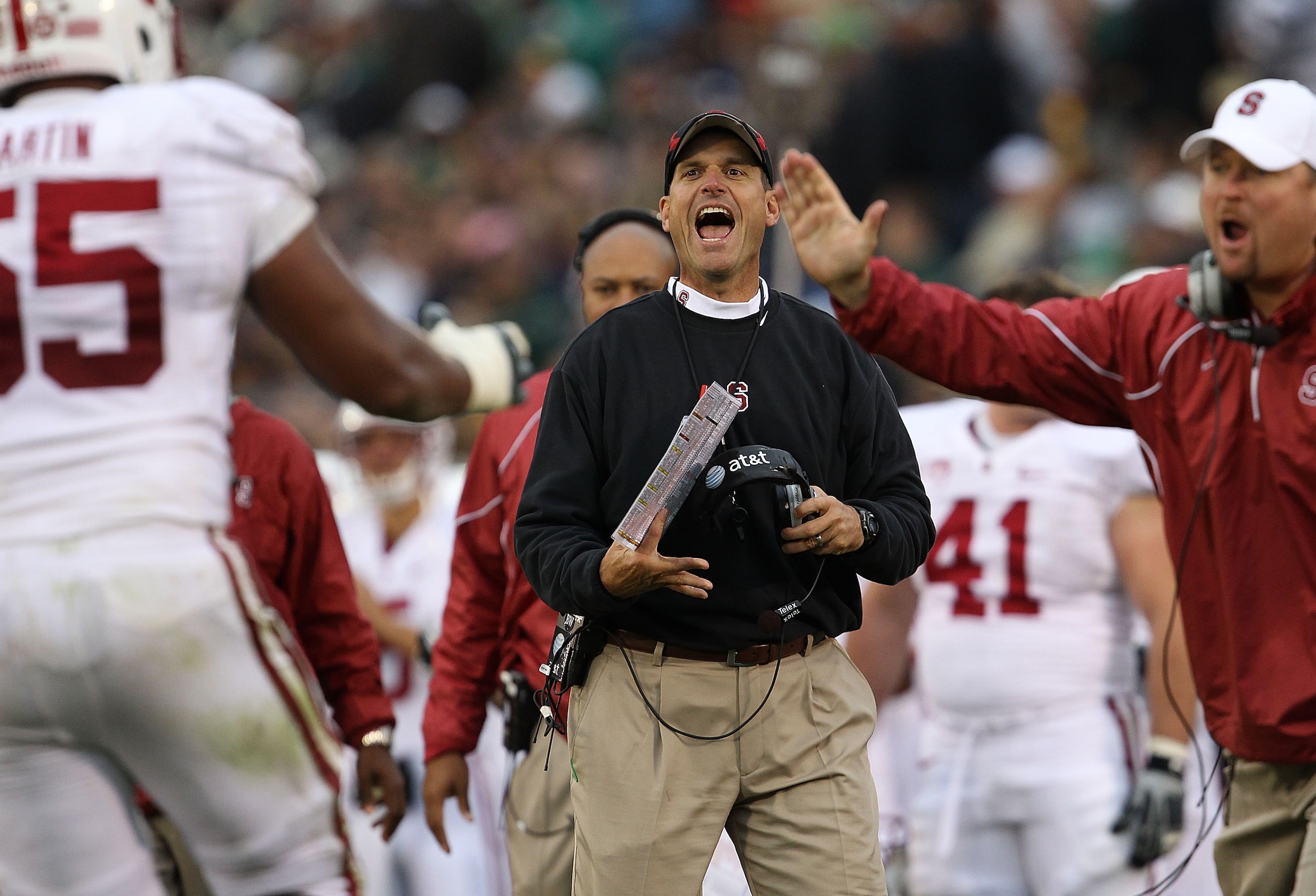 SOUTH BEND, IN - SEPTEMBER 25: Head coach Jim Harbaugh of the Stanford Cardinal smiles at Jonathan Martin #55 after a play against the Notre Dame Fighting Irish at Notre Dame Stadium on September 25, 2010 in South Bend, Indiana. Stanford defeated Notre Da SOUTH BEND, IN - SEPTEMBER 25: Head coach Jim Harbaugh of the Stanford Cardinal smiles at Jonathan Martin #55 after a play against the Notre Dame Fighting Irish at Notre Dame Stadium on September 25, 2010 in South Bend, Indiana. Stanford defeated Notre Da
