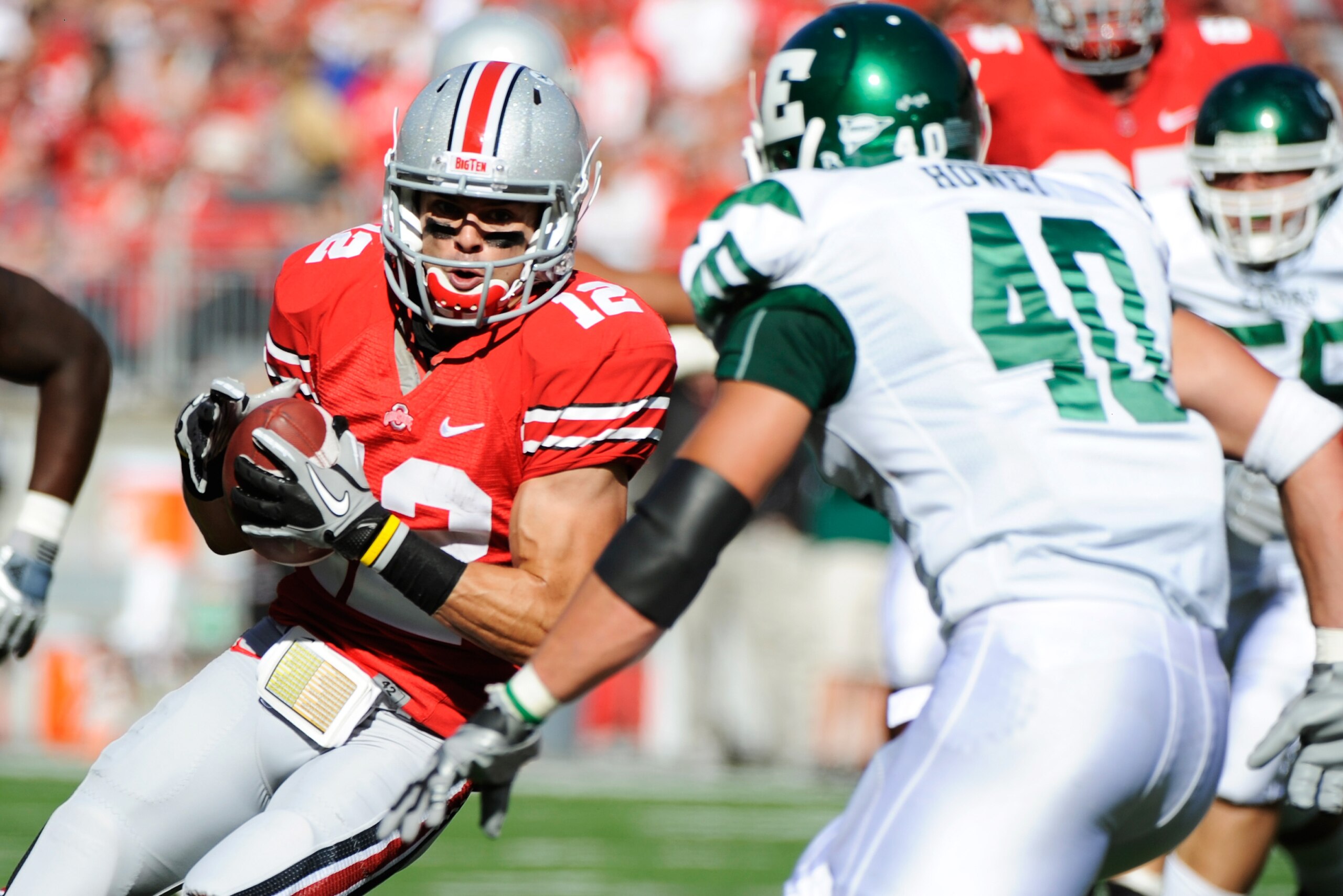 COLUMBUS, OH - SEPTEMBER 25: Dane Sanzenbacher #12 of the Ohio State Buckeyes looks for running room after catching a pass as Neal Howey #40 of the Eastern Michigan Eagles defends at Ohio Stadium on September 25, 2010 in Columbus, Ohio. Sanzenbacher had COLUMBUS, OH - SEPTEMBER 25: Dane Sanzenbacher #12 of the Ohio State Buckeyes looks for running room after catching a pass as Neal Howey #40 of the Eastern Michigan Eagles defends at Ohio Stadium on September 25, 2010 in Columbus, Ohio. Sanzenbacher had