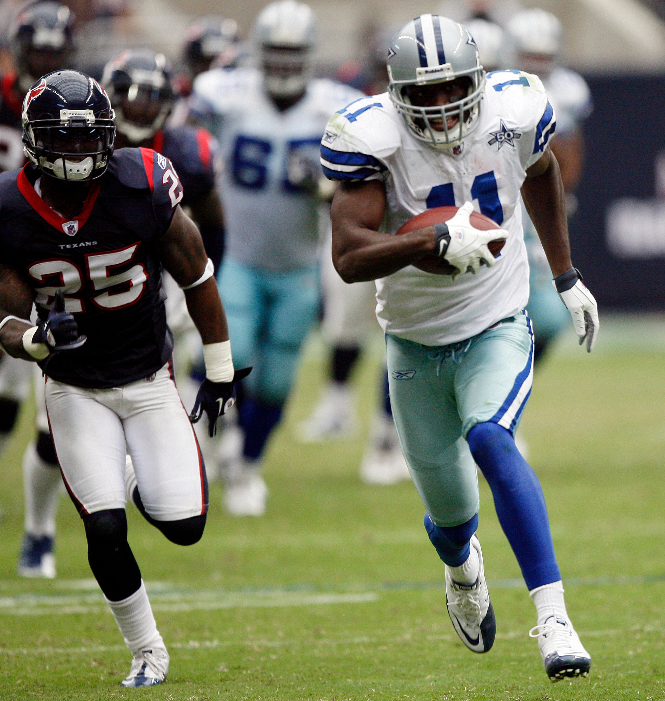 HOUSTON - SEPTEMBER 26:  Wide receiver Roy Williams #11 of the Dallas Cowboys runs away from Kareem Jackson #25 of the Houston Texans for a 63 yard touchdown in the fourth quarter at Reliant Stadium on September 26, 2010 in Houston, Texas.  (Photo by Bob