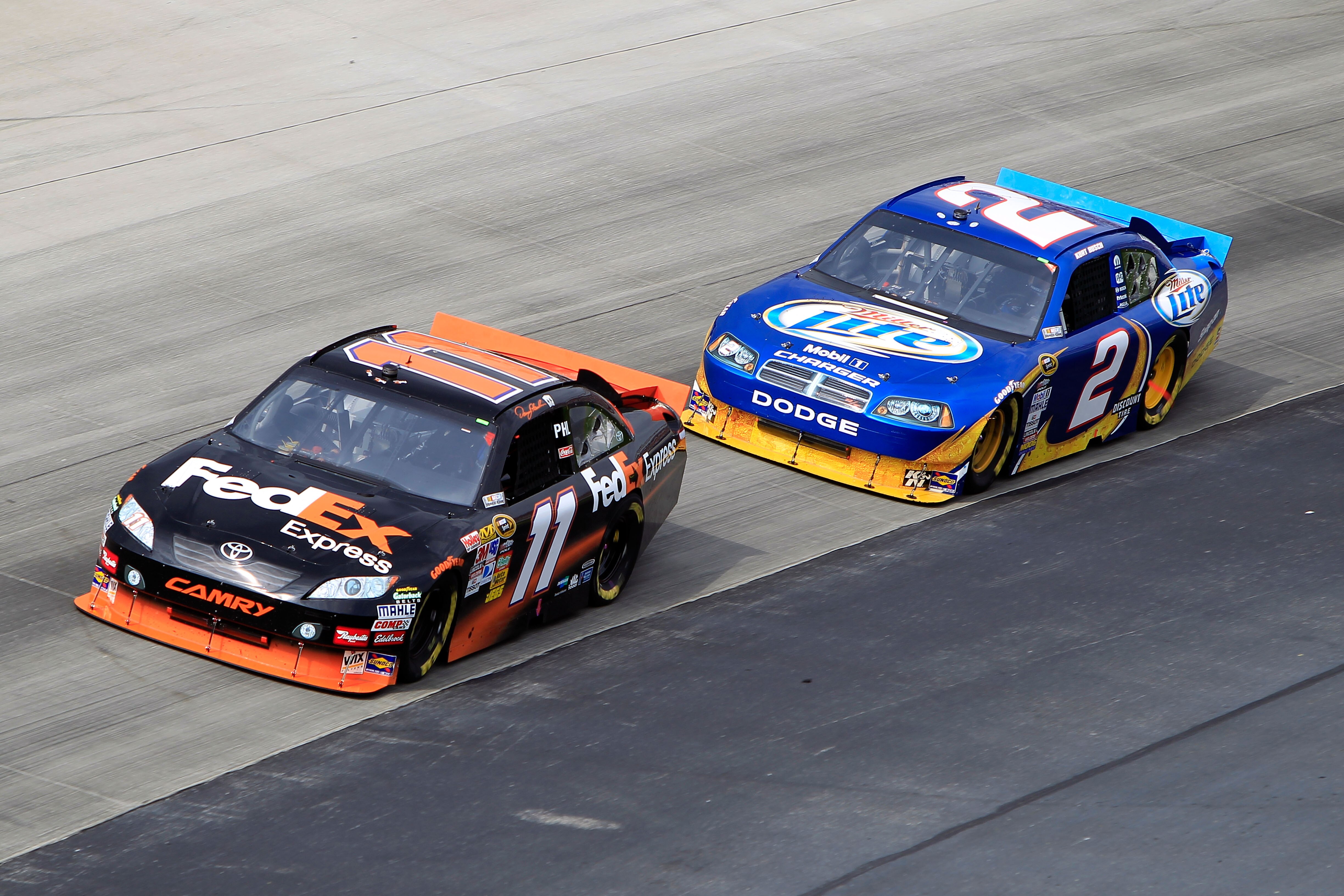 DOVER, DE - SEPTEMBER 26:  Denny Hamlin, driver of the #11 FedEx Express Toyota, leads Kurt Busch, driver of the #2 Miller Lite/Vortex Dodge, during the NASCAR Sprint Cup Series AAA 400 at Dover International Speedway on September 26, 2010 in Dover, Delaw