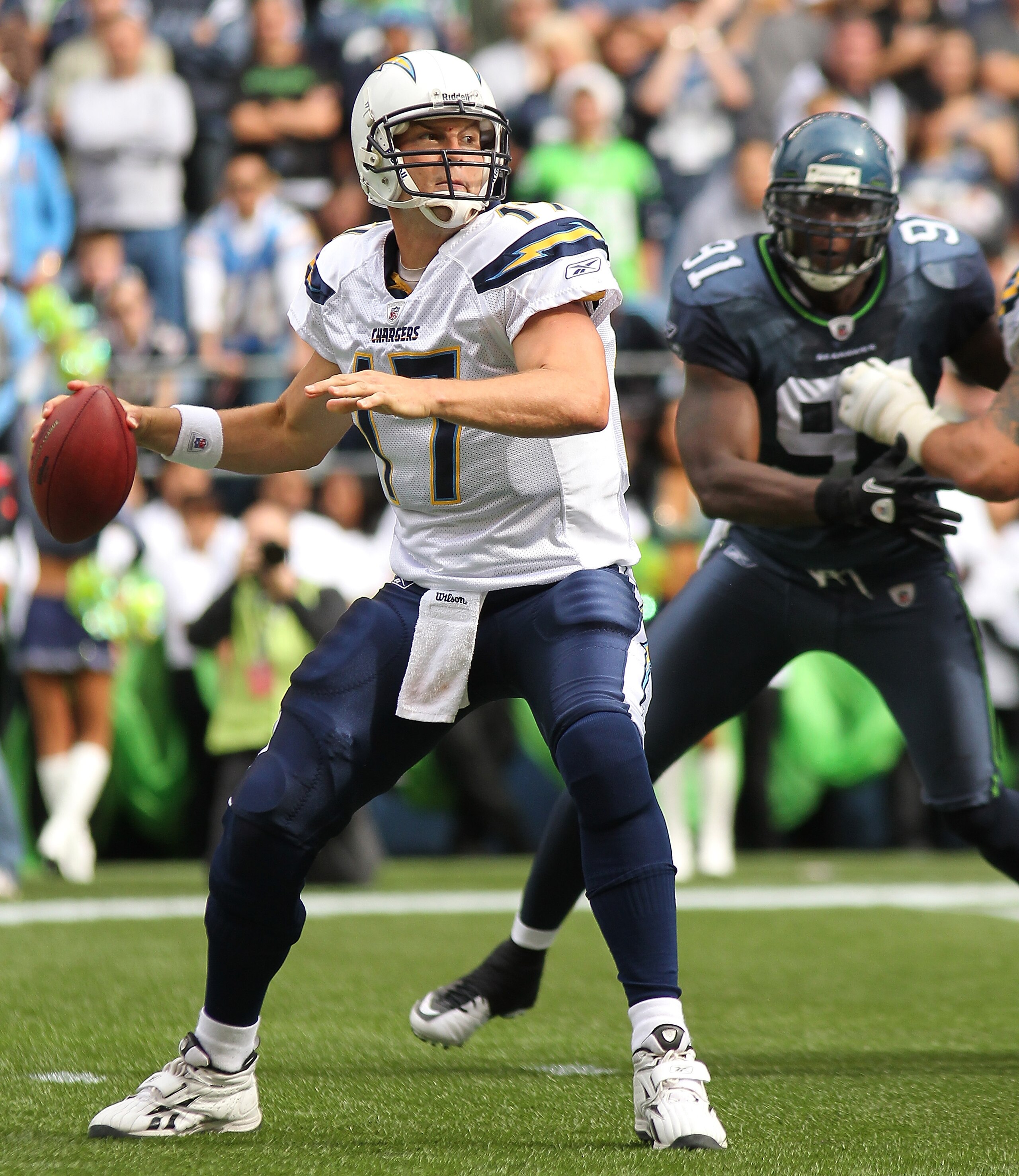 SEATTLE - SEPTEMBER 26:  Quarterback Philip Rivers #17 of the San Diego Chargers passes under pressure from Chris Clemons #91 of the Seattle Seahawks at Qwest Field on September 26, 2010 in Seattle, Washington. The Seahawks defeated the Chargers 27-20.(Ph