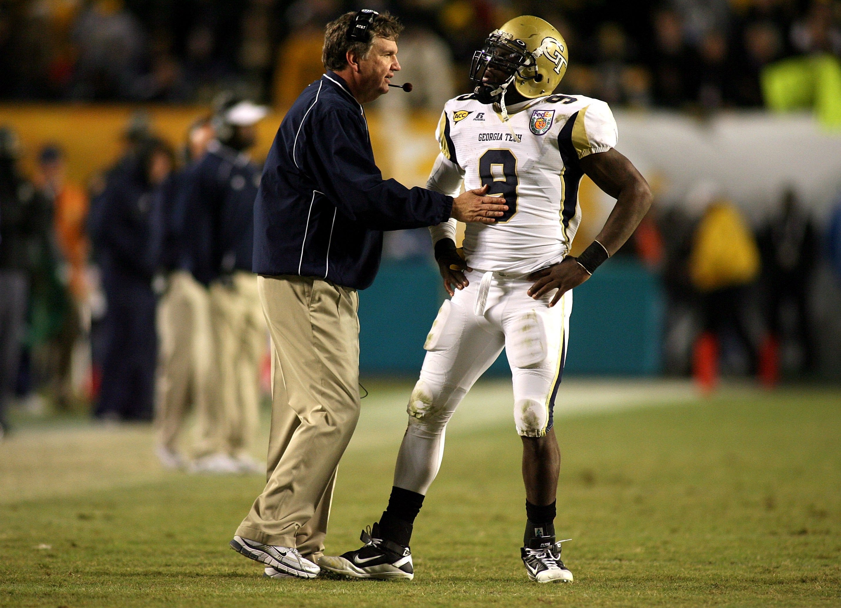 MIAMI GARDENS, FL - JANUARY 05:  Head coach Paul Johnson of the Georgia Tech Yellow Jackets talks with quarterback Josh Nesbitt #9 against the Iowa Hawkeyes during the FedEx Orange Bowl at Land Shark Stadium on January 5, 2010 in Miami Gardens, Florida.