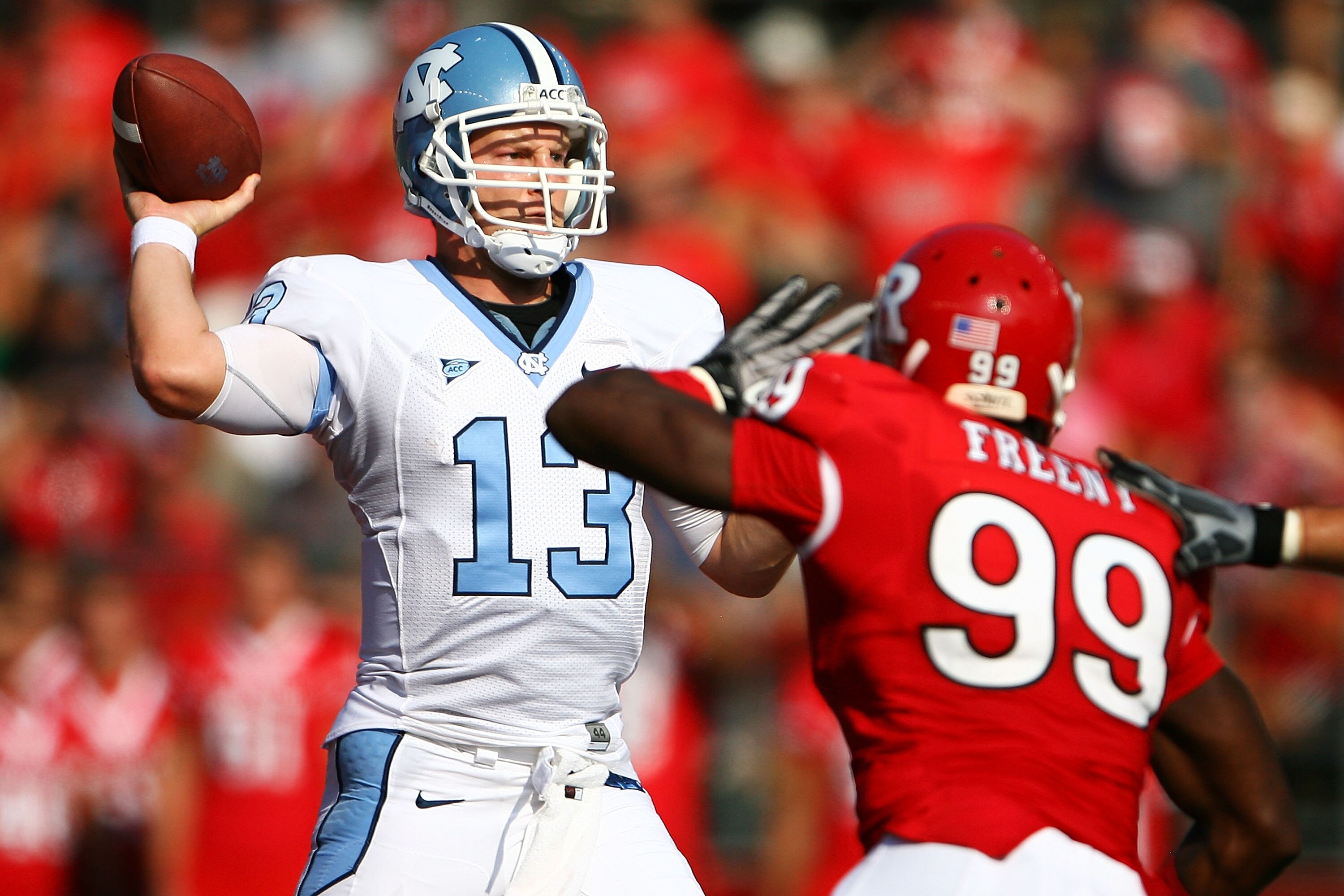 NEW BRUNSWICK, NJ - SEPTEMBER 25: Jonathan Freeny #99 of the Rutgers Scarlet Knights attempts to block a pass from  T.J. Yates #13 of the North Carolina Tar Heels during a game at Rutgers Stadium on September 25, 2010 in New Brunswick, New Jersey.  (Photo