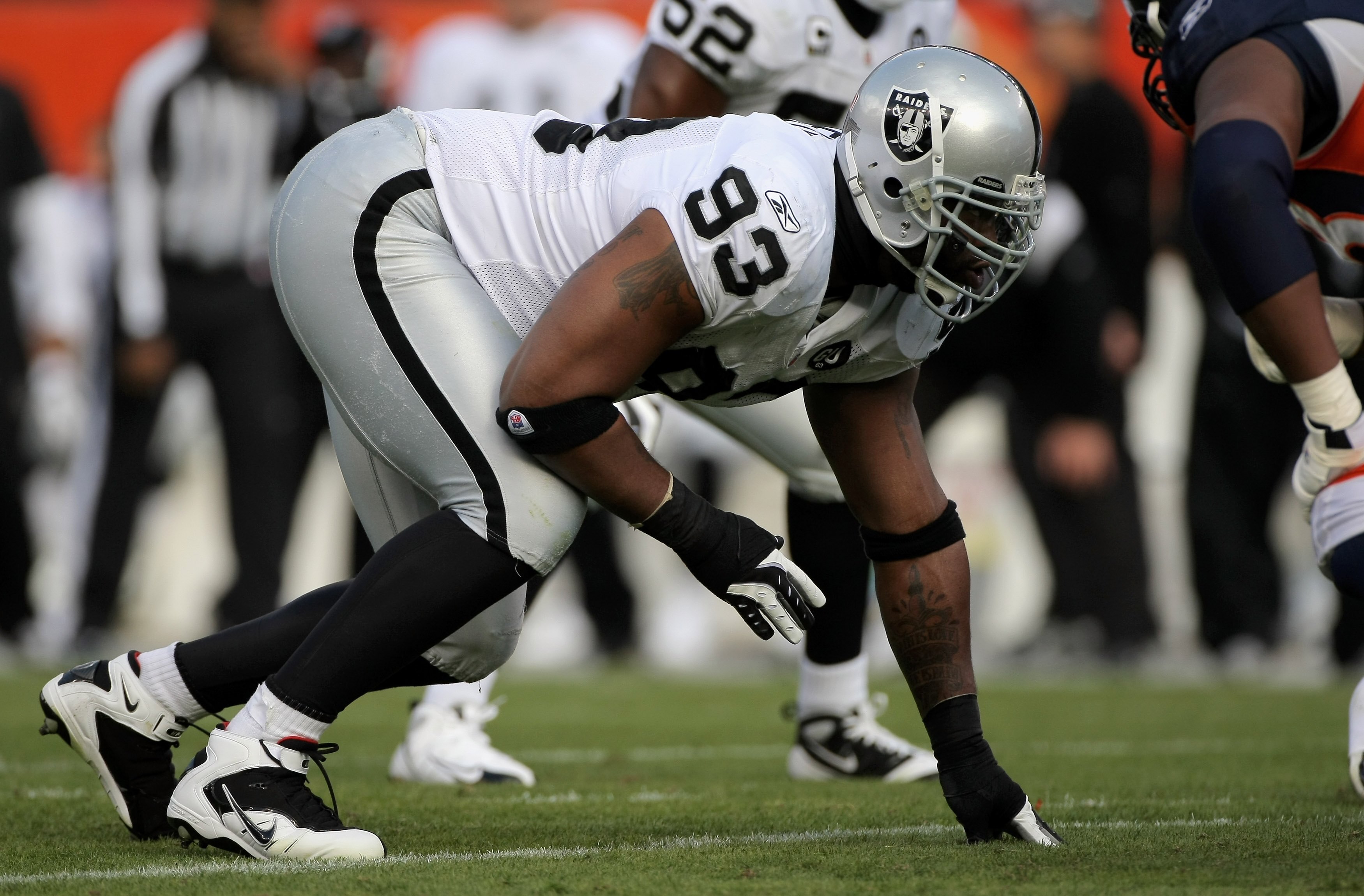DENVER - NOVEMBER 23:  Defensive tackle Tommy Kelly #93 of the Oakland Raiders defends against the Denver Broncos during week 12 NFL action at Invesco Field at Mile High on November 23, 2008 in Denver, Colorado. The Raiders defeated the Broncos 31-10.  (P