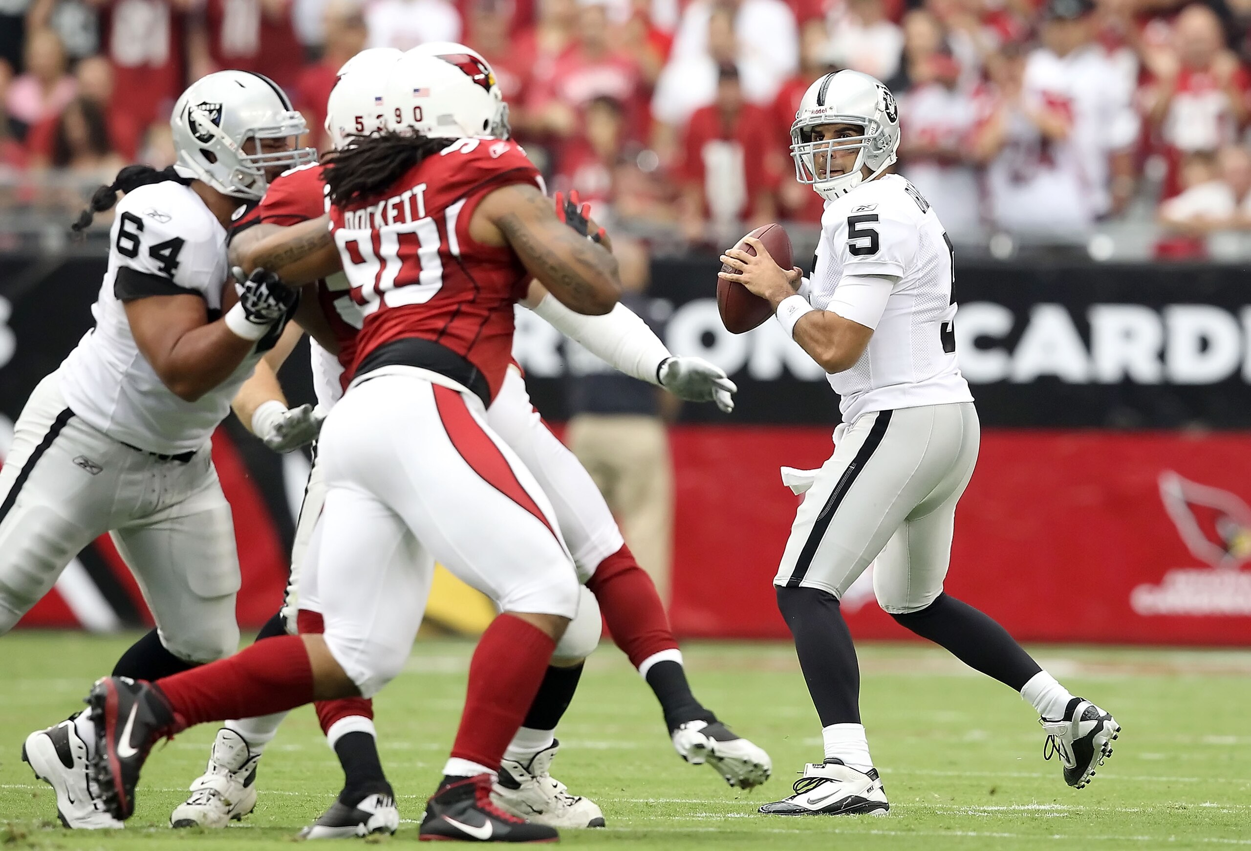 GLENDALE, AZ - SEPTEMBER 26:  Quarterback Bruce Gradkowski #5 of the Oakland Raiders drops back to pass during the NFL game against the Arizona Cardinals at the University of Phoenix Stadium on September 26, 2010 in Glendale, Arizona.  (Photo by Christian