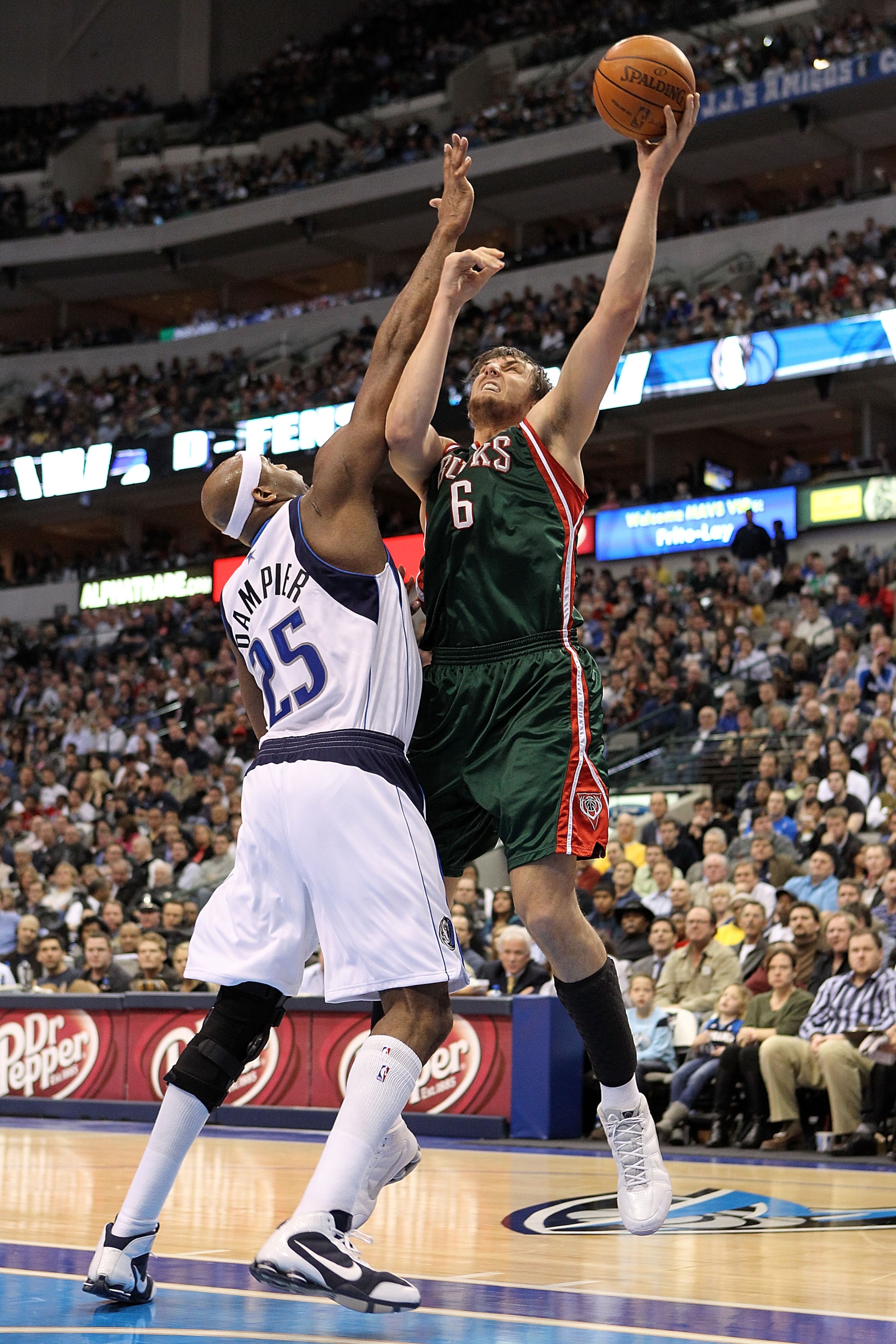 DALLAS - JANUARY 26:  Center Andrew Bogut #6 of the Milwaukee Bucks takes a shot against Erick Dampier #25 of the Dallas Mavericks on January 26, 2010 at American Airlines Center in Dallas, Texas.  NOTE TO USER: User expressly acknowledges and agrees that