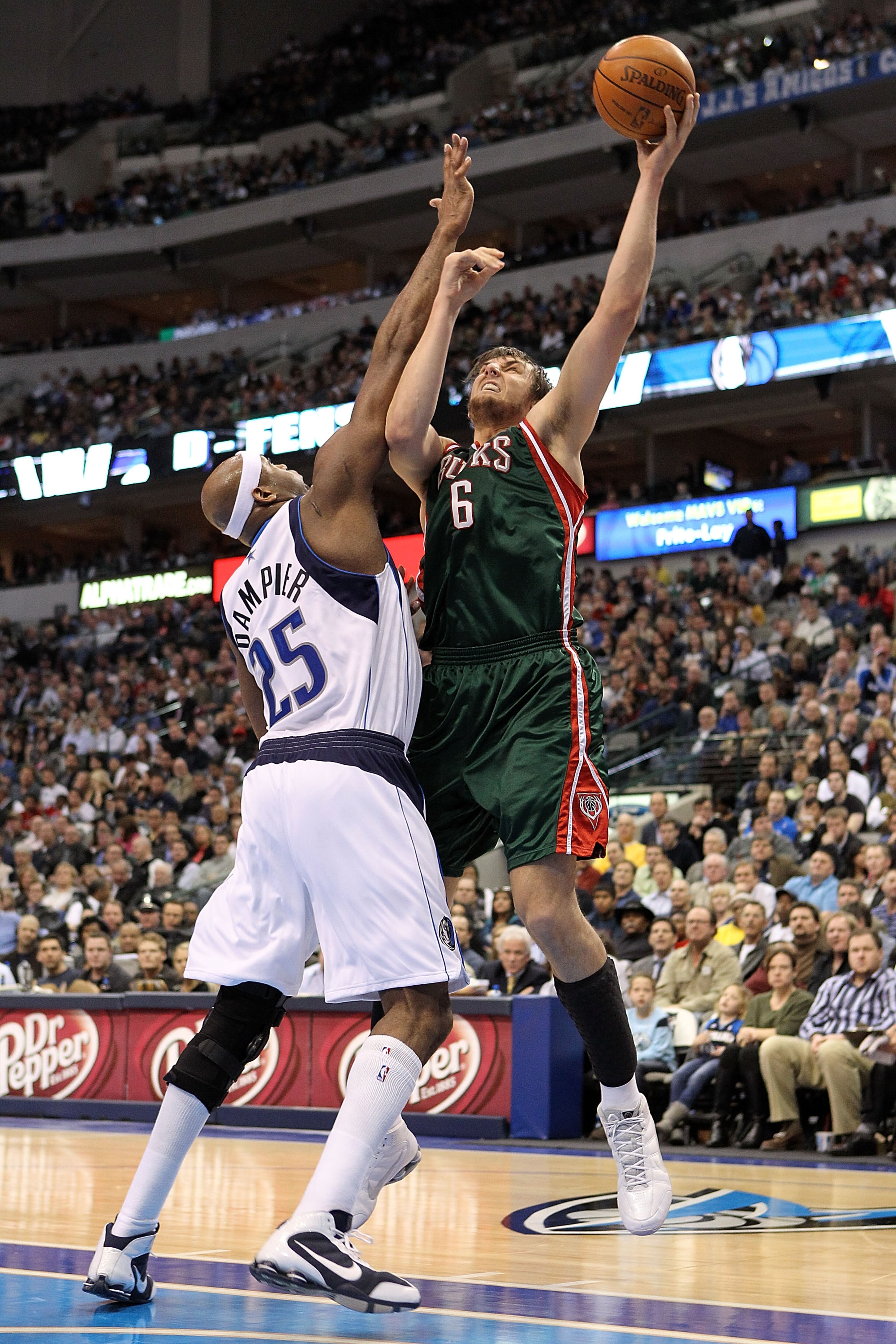 DALLAS - JANUARY 26:  Center Andrew Bogut #6 of the Milwaukee Bucks takes a shot against Erick Dampier #25 of the Dallas Mavericks on January 26, 2010 at American Airlines Center in Dallas, Texas.  NOTE TO USER: User expressly acknowledges and agrees that