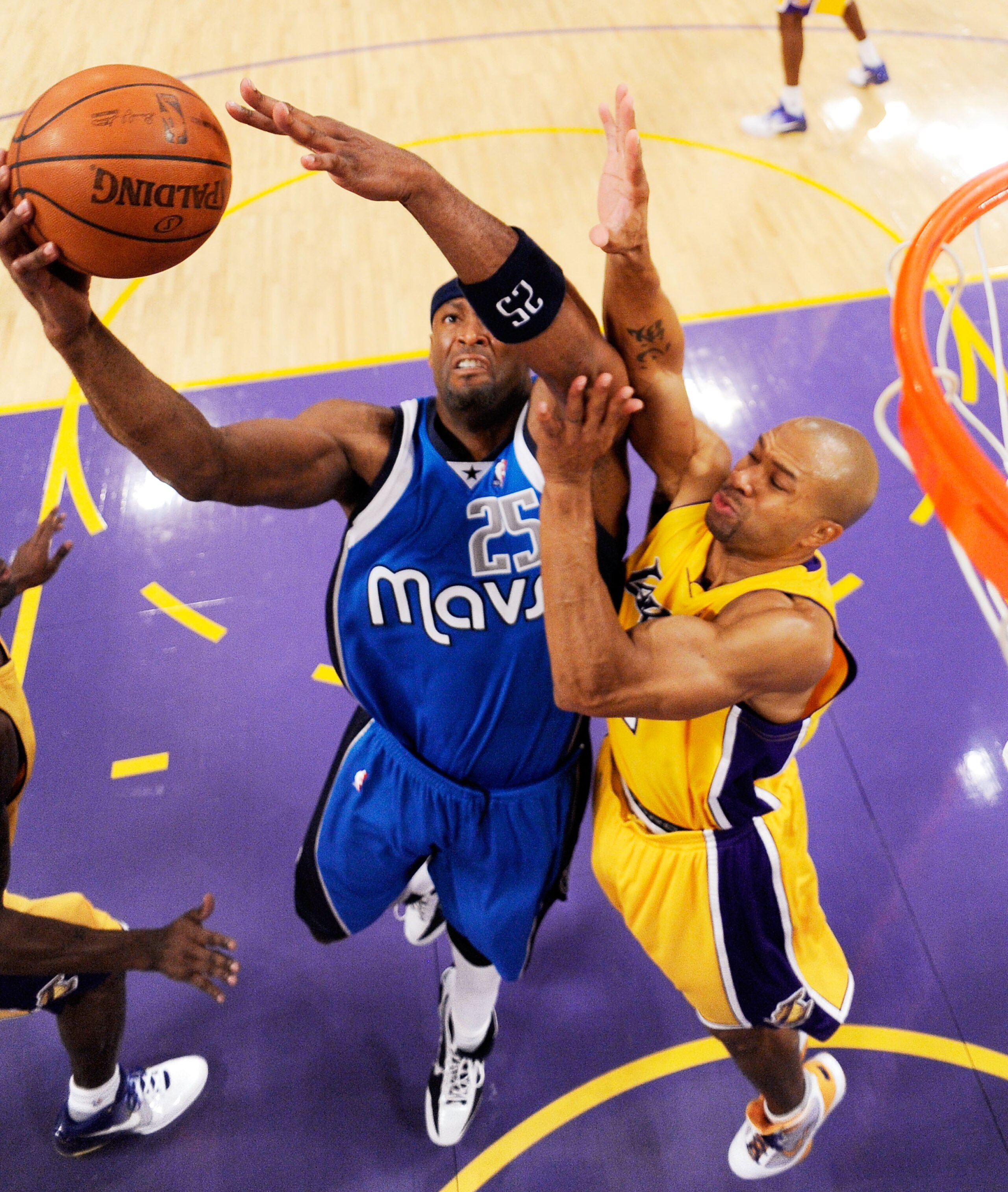 LOS ANGELES, CA - OCTOBER 30: Erick Dampier #25 (L)  of the Dallas Mavericks fight for a rebound against Derek Fisher #2 of the Los Angekes Lakers during the basketball game at Staples Center on October 30, 2009 in Los Angeles, California. NOTE TO USER: U