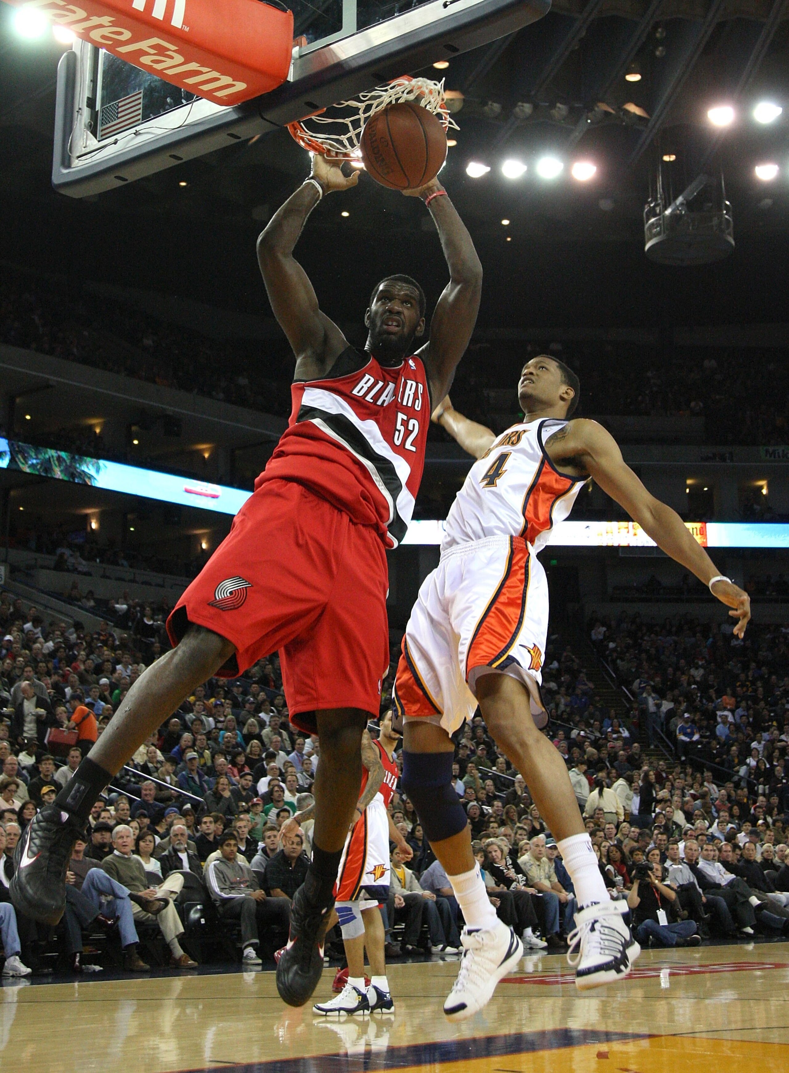 OAKLAND, CA - NOVEMBER 20:  Greg Oden #52 of the Portland Trail Blazers dunks over Anthony Randolph #4 of the Golden State Warriors during an NBA game at Oracle Arena on November 20, 2009 in Oakland, California.  (Photo by Jed Jacobsohn/Getty Images)