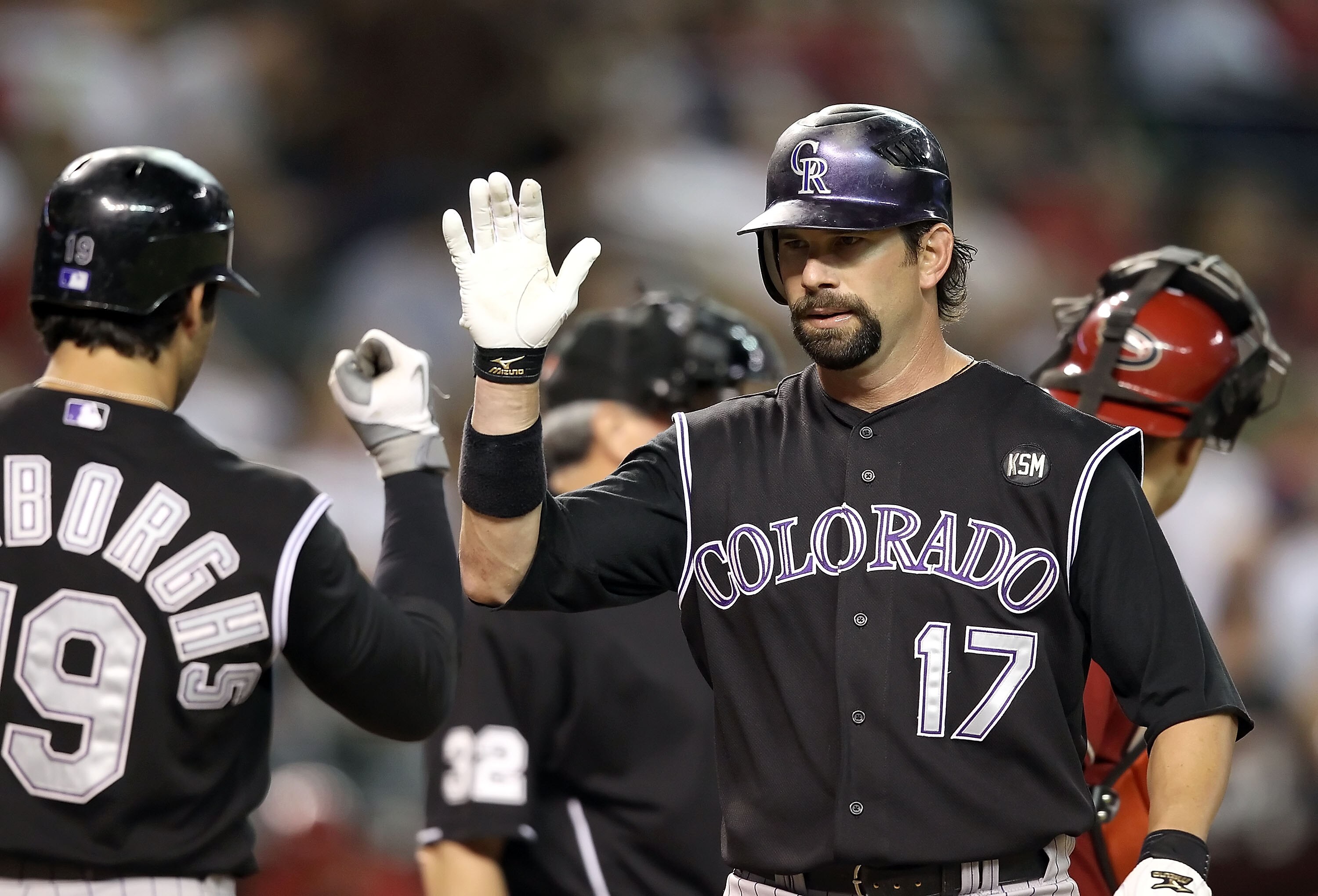 PHOENIX - SEPTEMBER 22: Todd Helton #17 of the Colorado Rockies high fives teammate Ryan Spilborghs #16 after Helton hit a solo home run against the Arizona Diamondbacks during the first inning of the Major League Baseball game at Chase Field on Septembe PHOENIX - SEPTEMBER 22: Todd Helton #17 of the Colorado Rockies high fives teammate Ryan Spilborghs #16 after Helton hit a solo home run against the Arizona Diamondbacks during the first inning of the Major League Baseball game at Chase Field on Septembe