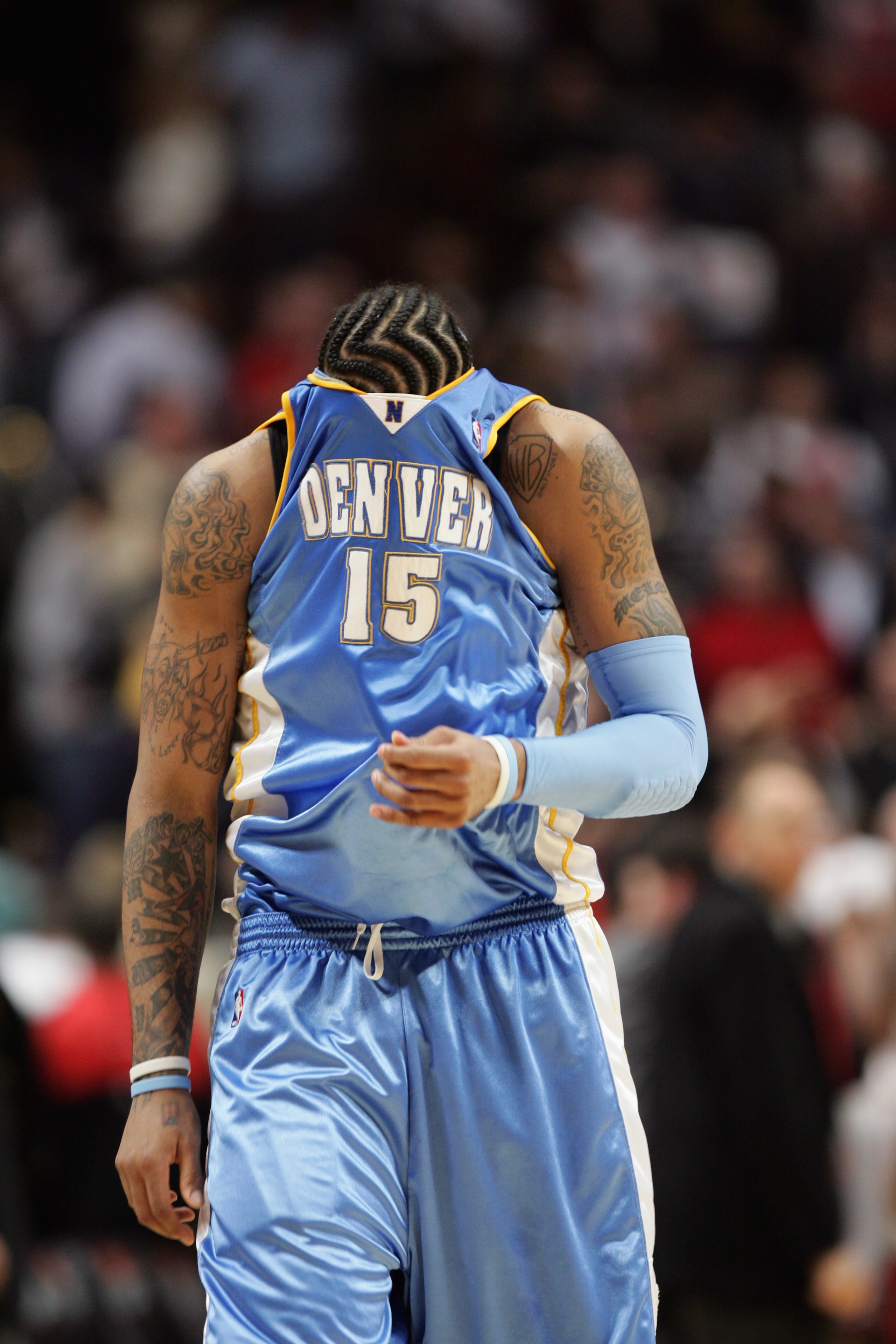 CHICAGO - MARCH 22:  Carmelo Anthony #15 of the Denver Nuggets walks upcourt with his jersey pulled over his face during the game against the Chicago Bulls on March 22, 2007 at the United Center in Chicago, Illinois. The Bulls won 109-108.  NOTE TO USER: