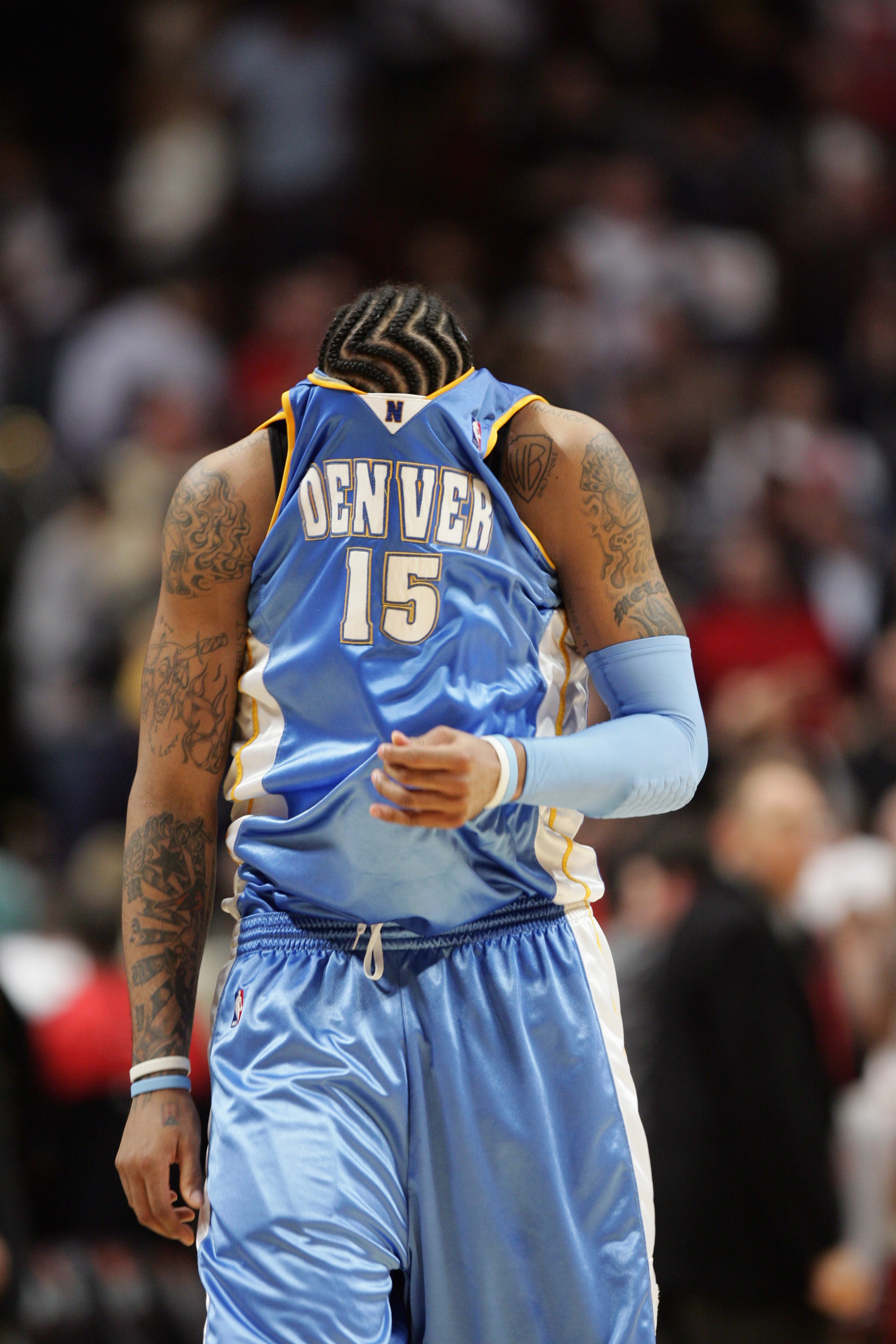 CHICAGO - MARCH 22:  Carmelo Anthony #15 of the Denver Nuggets walks upcourt with his jersey pulled over his face during the game against the Chicago Bulls on March 22, 2007 at the United Center in Chicago, Illinois. The Bulls won 109-108.  NOTE TO USER: