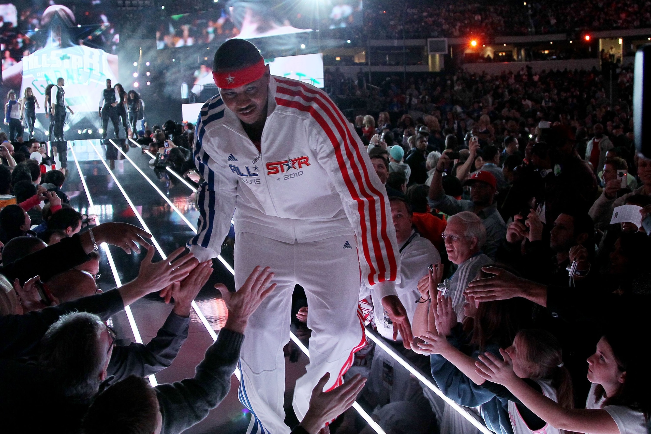 ARLINGTON, TX - FEBRUARY 14:  Carmelo Anthony #15 of the Western Conference shakes hands with fans during introductions before the NBA All-Star Game, part of 2010 NBA All-Star Weekend at Cowboys Stadium on February 14, 2010 in Arlington, Texas. NOTE TO US
