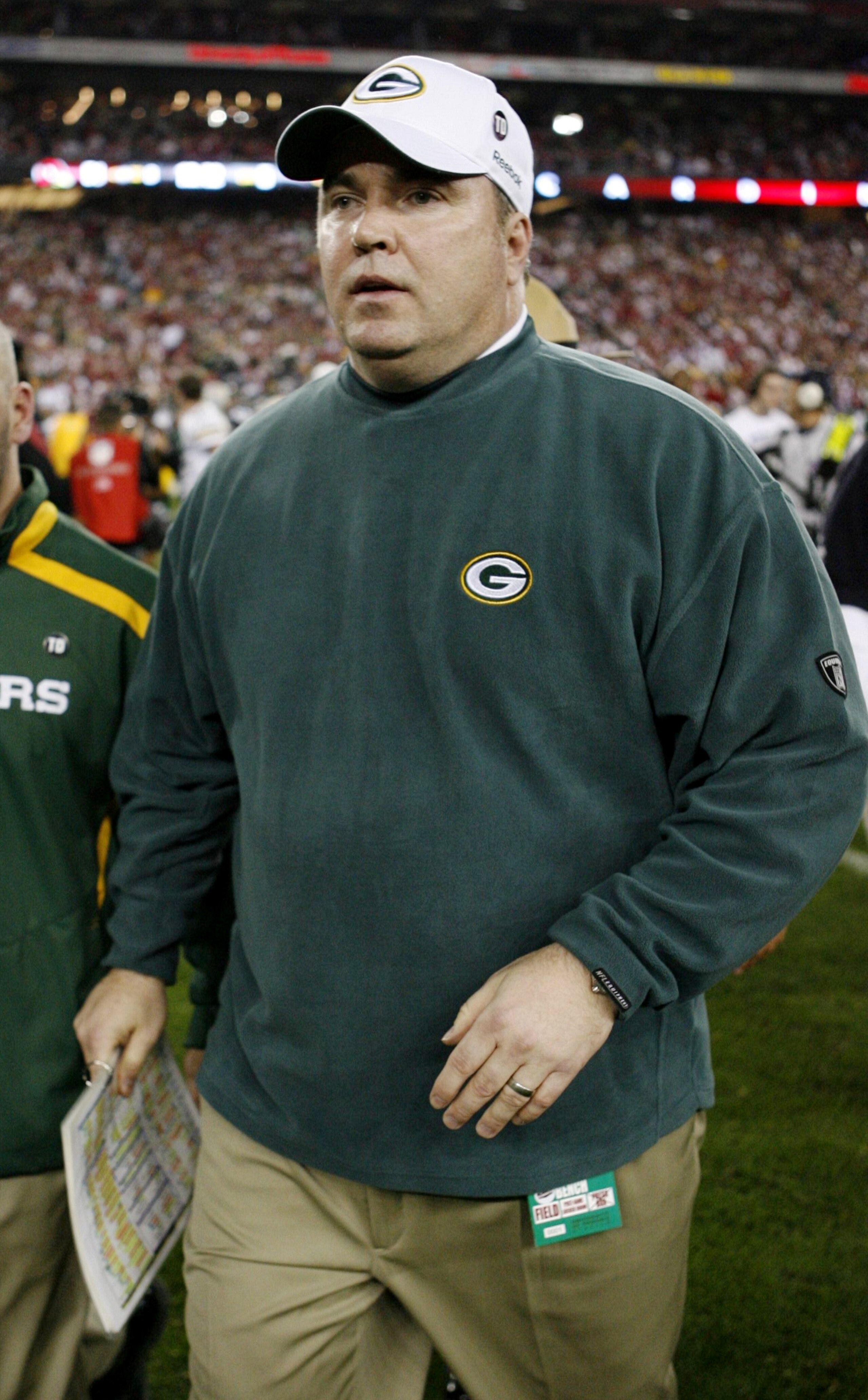 GLENDALE, AZ - JANUARY 10:  Head coach Mike McCarthy of the Green Bay Packers leaves the field after his team was defeated 51-45 by the Arizona Cardinals in overtime in the 2010 NFC wild-card playoff game at University of Phoenix Stadium on January 10, 20