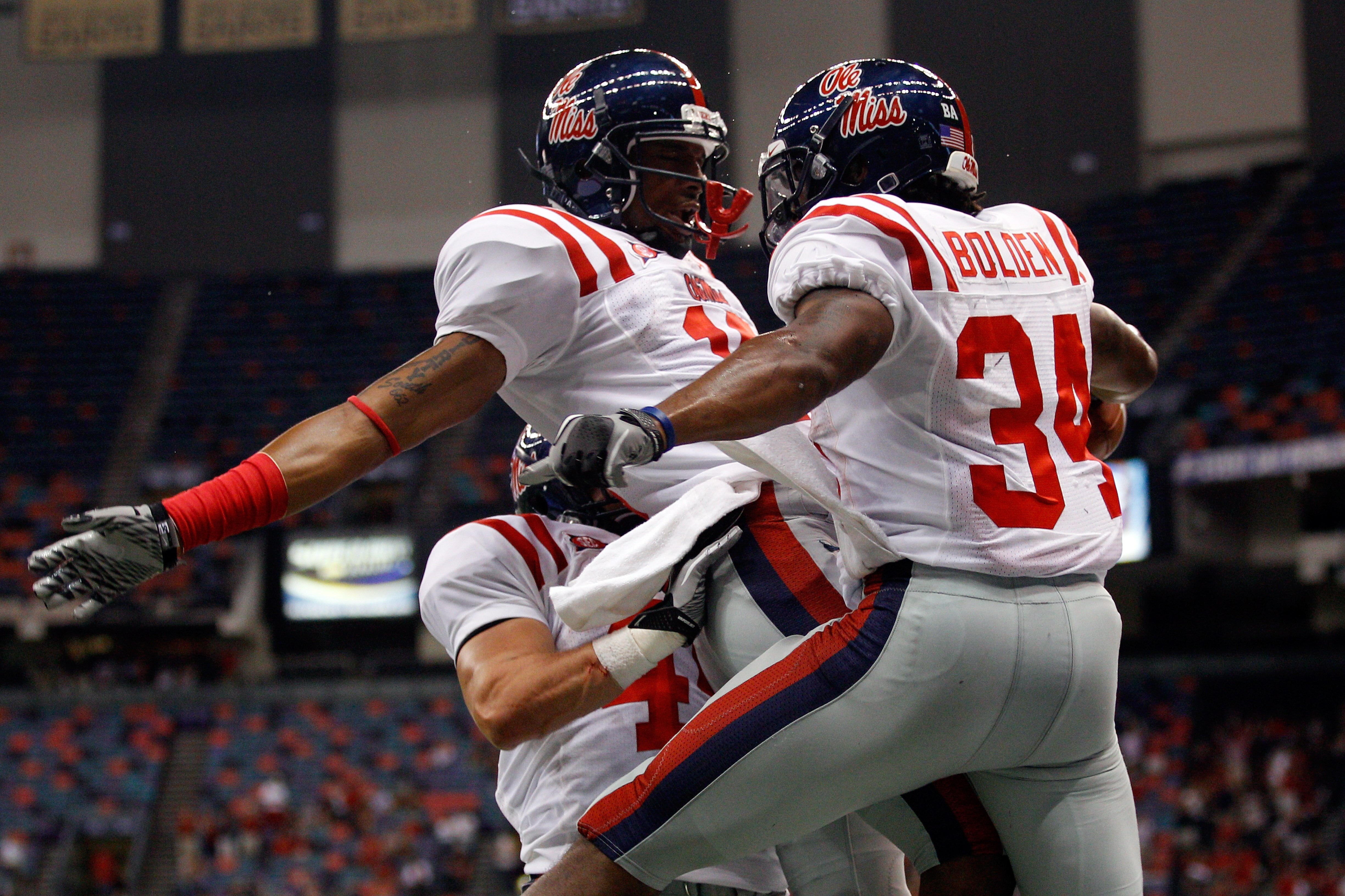 NEW ORLEANS - SEPTEMBER 11:  Brandon Bolden #34 celebrates with Markeith Summers #16 of the Ole Miss Rebels after scoring a touchdown against the Tulane Green Wave at the Louisiana Superdome on September 11, 2010 in New Orleans, Louisiana.  (Photo by Chri