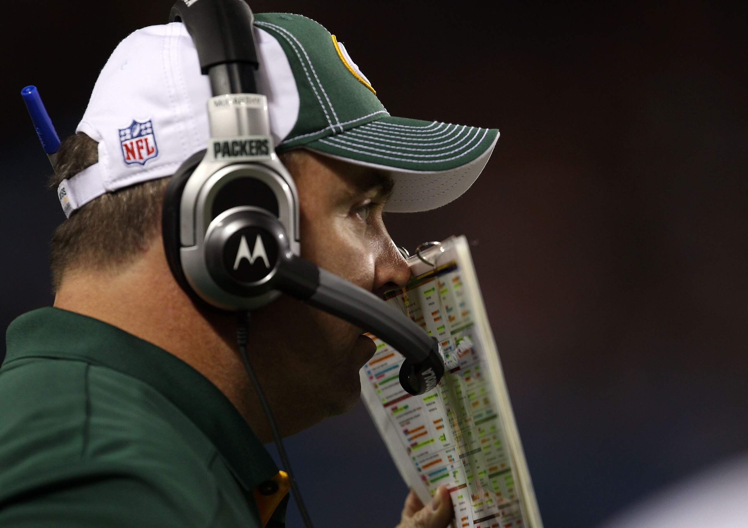 CHICAGO - SEPTEMBER 27:  Head coach Mike McCarthy of the Green Bay Packers talks into his headset against the Chicago Bears at Soldier Field on September 27, 2010 in Chicago, Illinois.  (Photo by Jonathan Daniel/Getty Images)