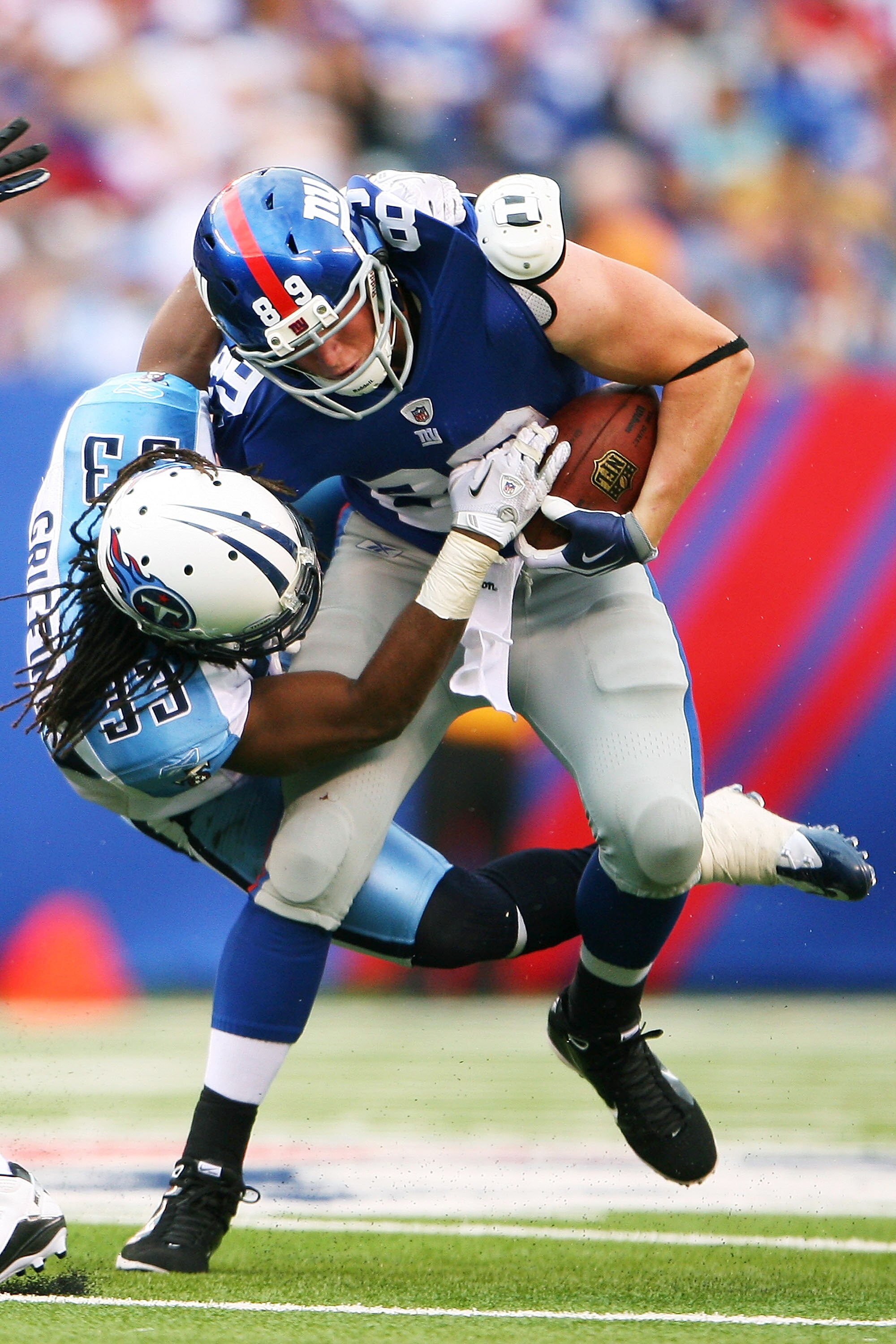 EAST RUTHERFORD, NJ - SEPTEMBER 26: Michael Griffin #33 of the Tennessee Titans tackles Kevin Boss #89 of the New York Giants at New Meadowlands Stadium on September 26, 2010 in East Rutherford, New Jersey. The Titans defeated the Giants 29 - 10. (Photo b