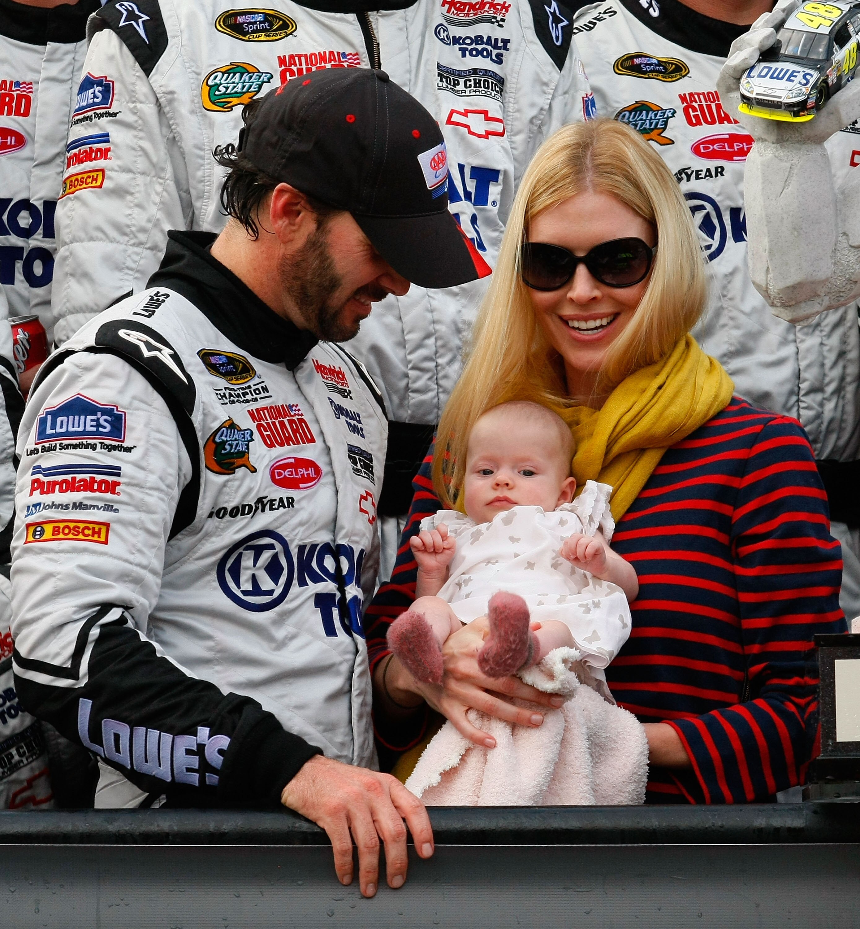 DOVER, DE - SEPTEMBER 26: (L-R) Jimmie Johnson, driver of the #48 Lowe's/Kobalt Tools Chevrolet, celebrates in Victory Lane with daughter Genevieve Marie and wife Chandra after winning the NASCAR Sprint Cup Series AAA 400 at Dover International Speedway o
